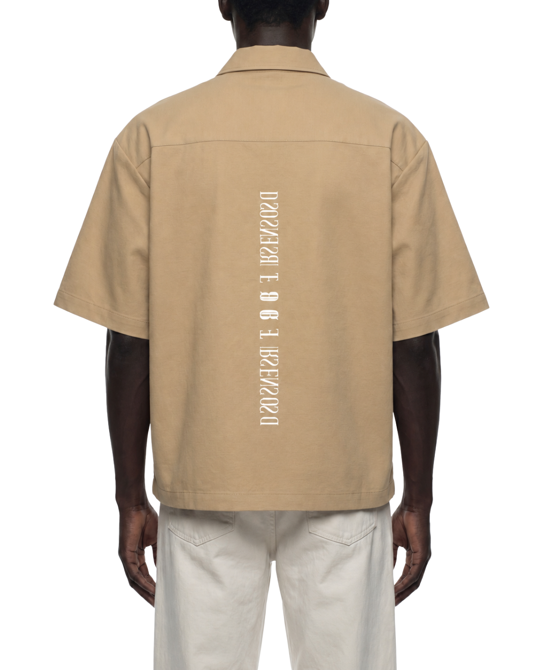 Beige short-sleeve shirt with branding on the back worn by a person on a white background