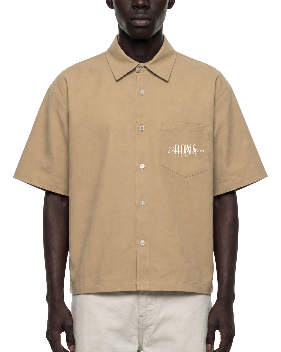 Man wearing a beige short-sleeve shirt with a brand logo on a white background