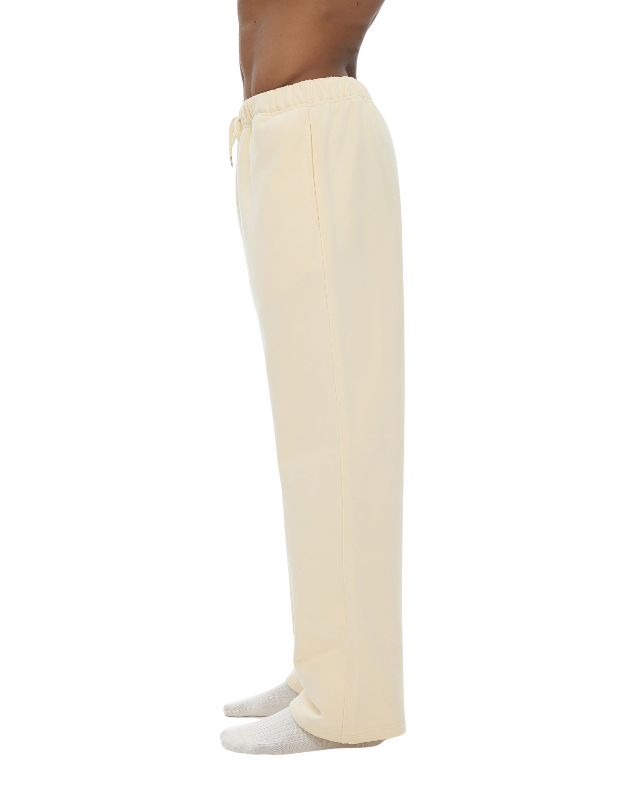 Beige pants worn by a person on a white background