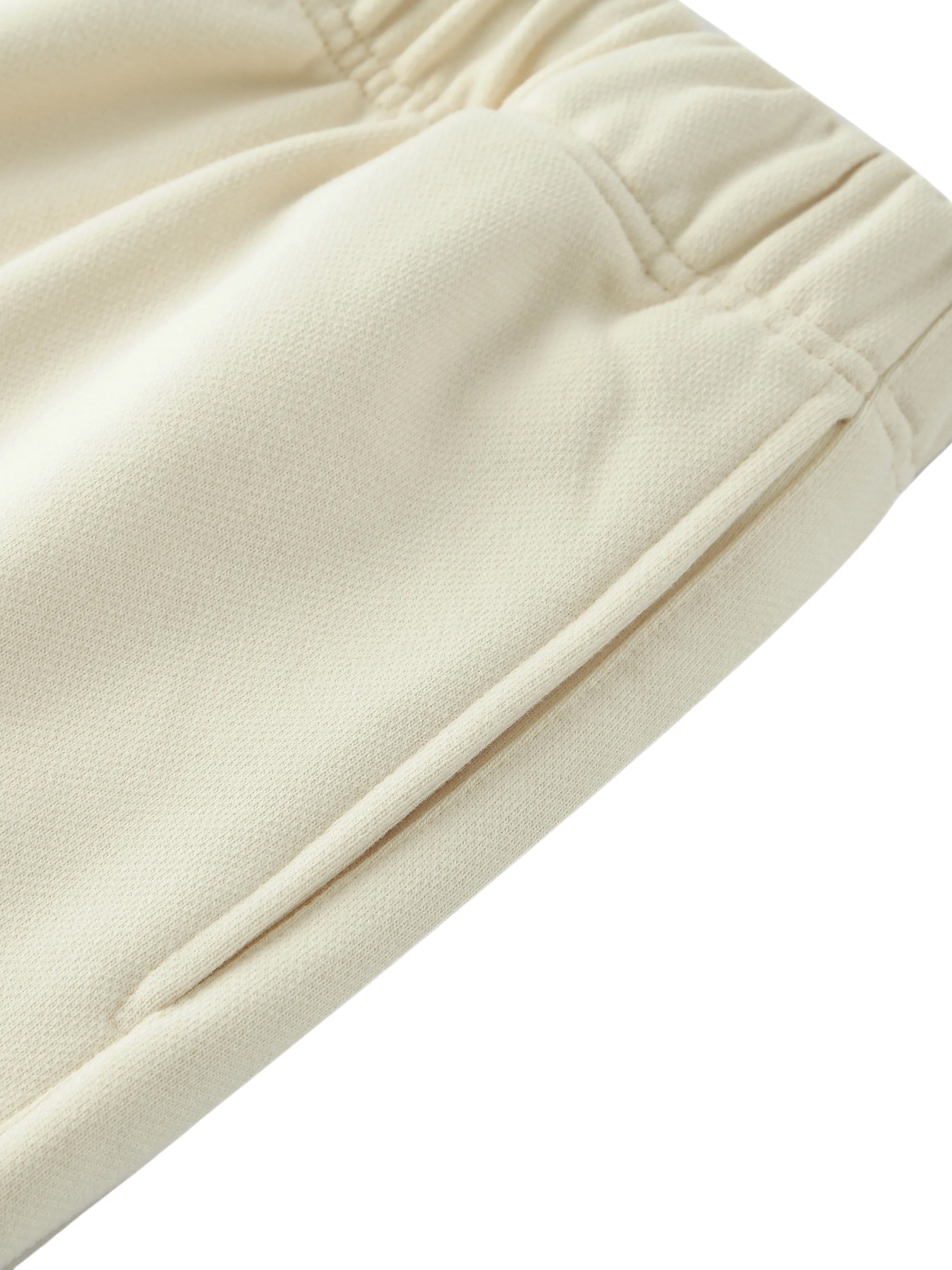 Close-up of beige fabric with a subtle texture on a white background