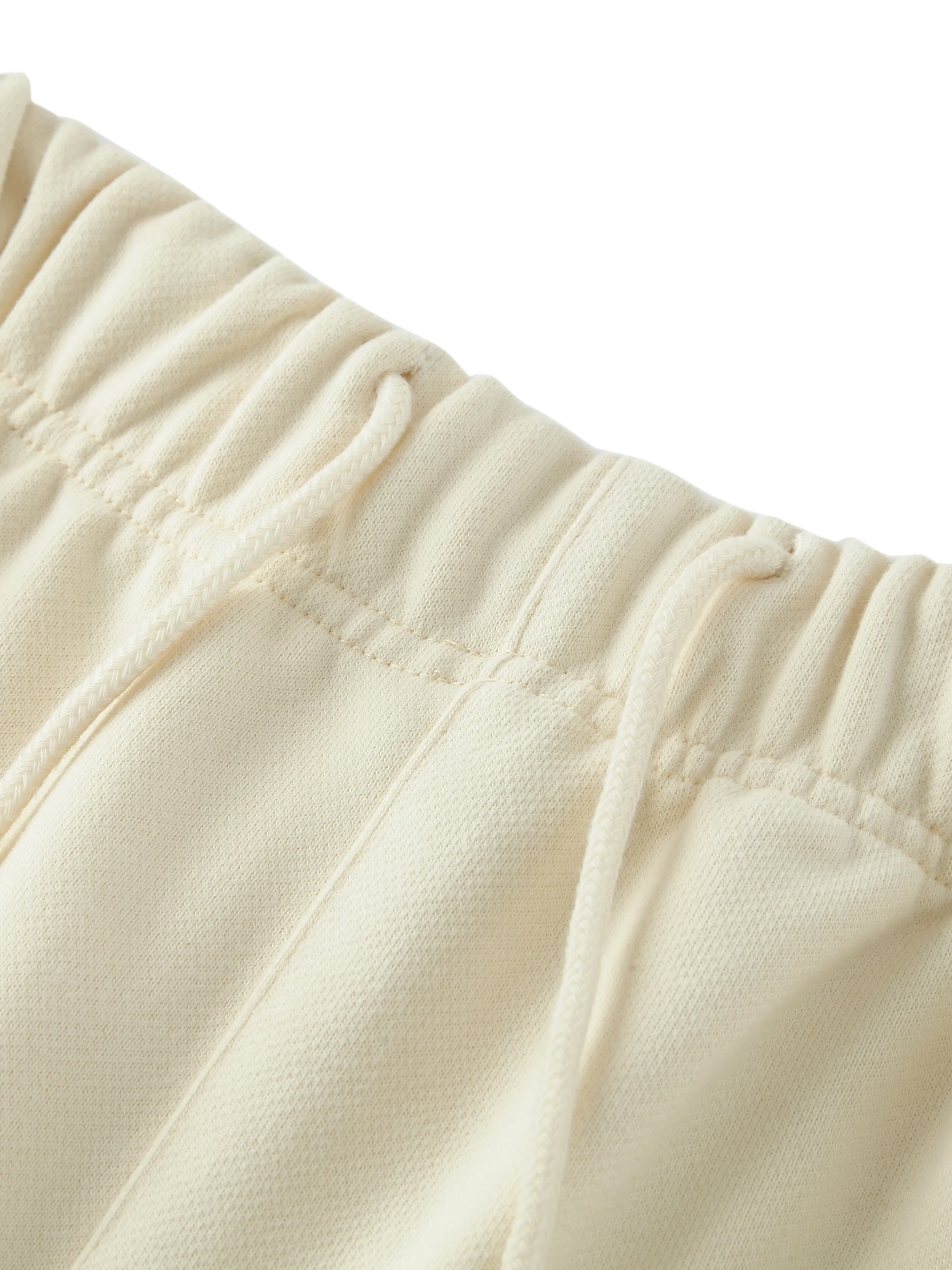Close-up of beige fleece fabric with a focus on texture and stitching.