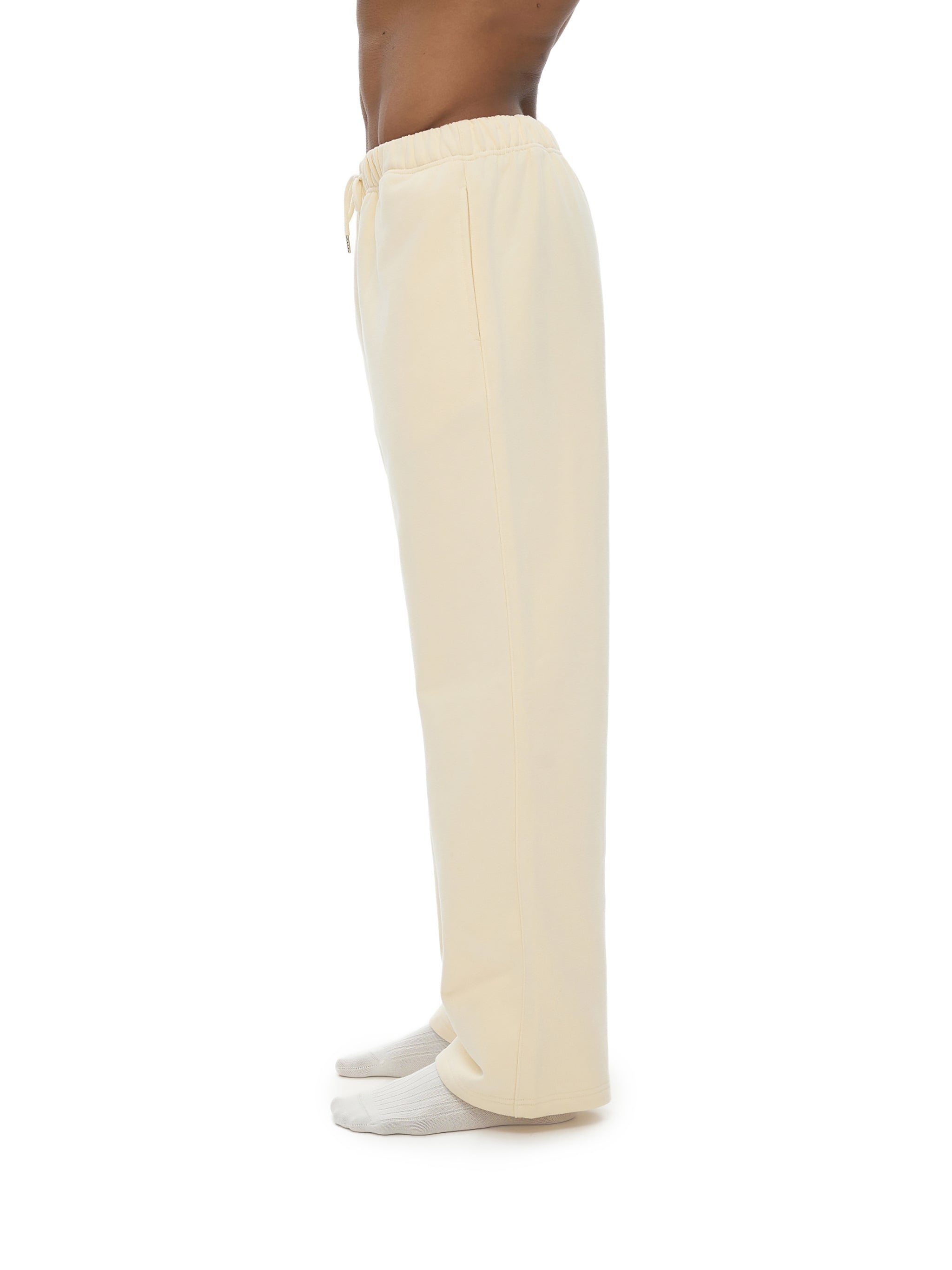 Beige pants worn by a person on a white background