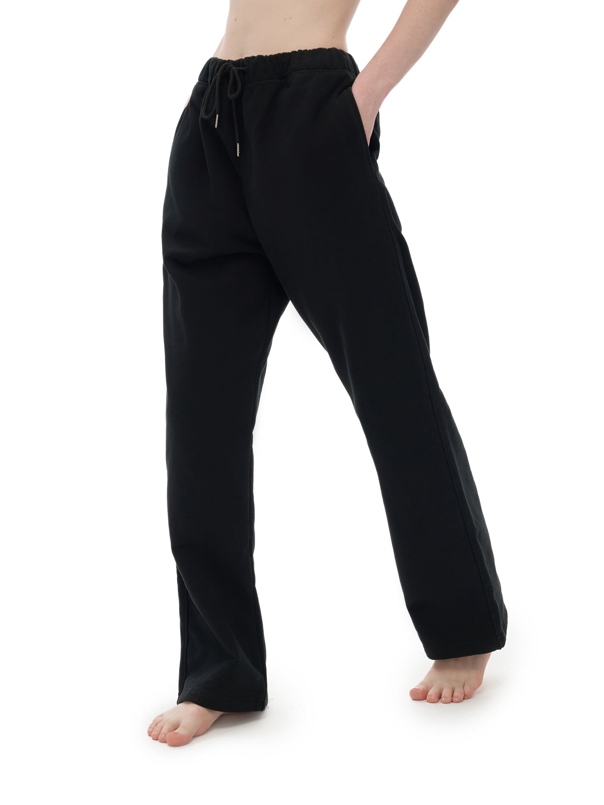 Black pants worn by a person on a white background