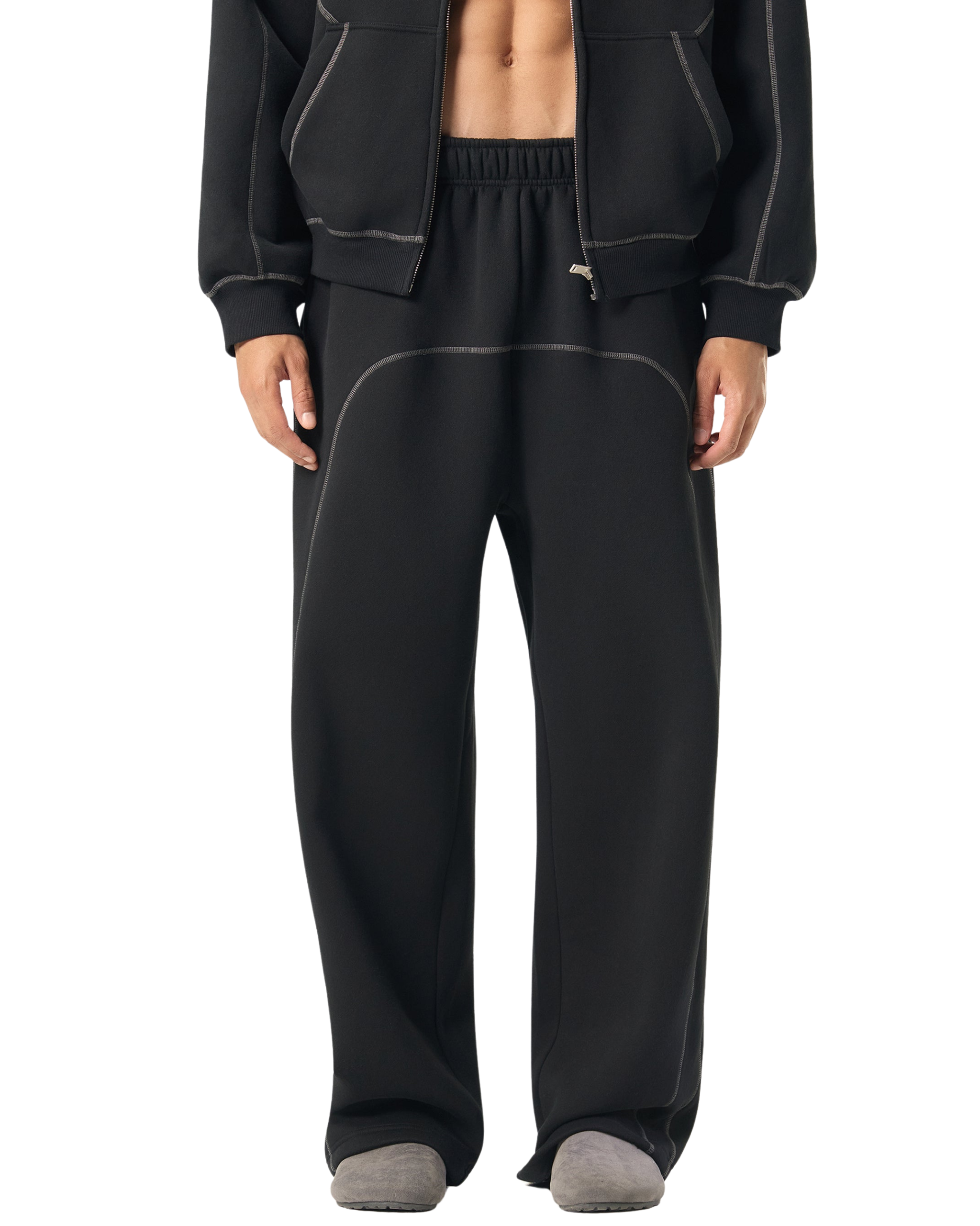 Person wearing black tracksuit with jacket and pants on a transparent background
