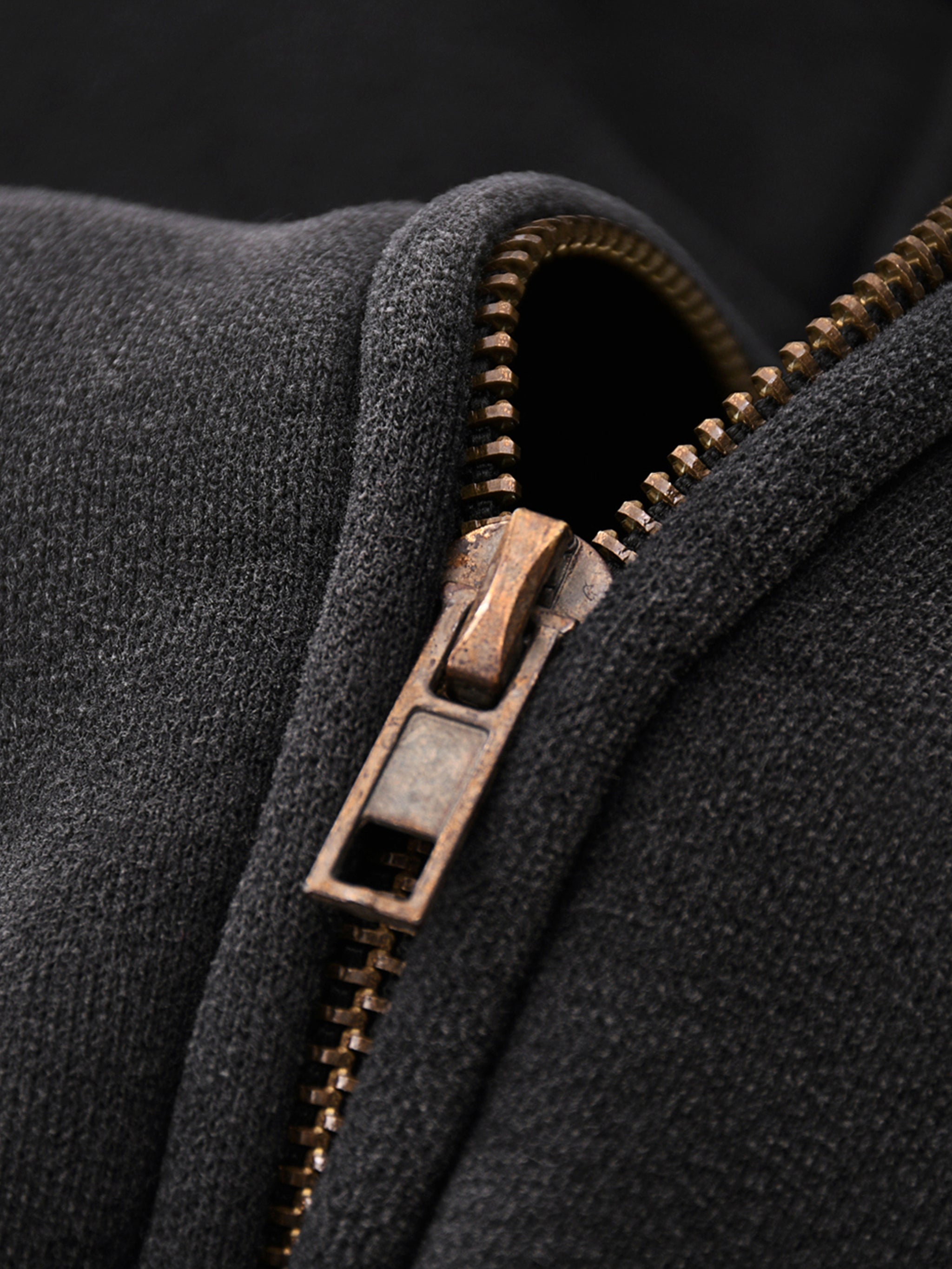 Close-up of a zip on a dark fabric background