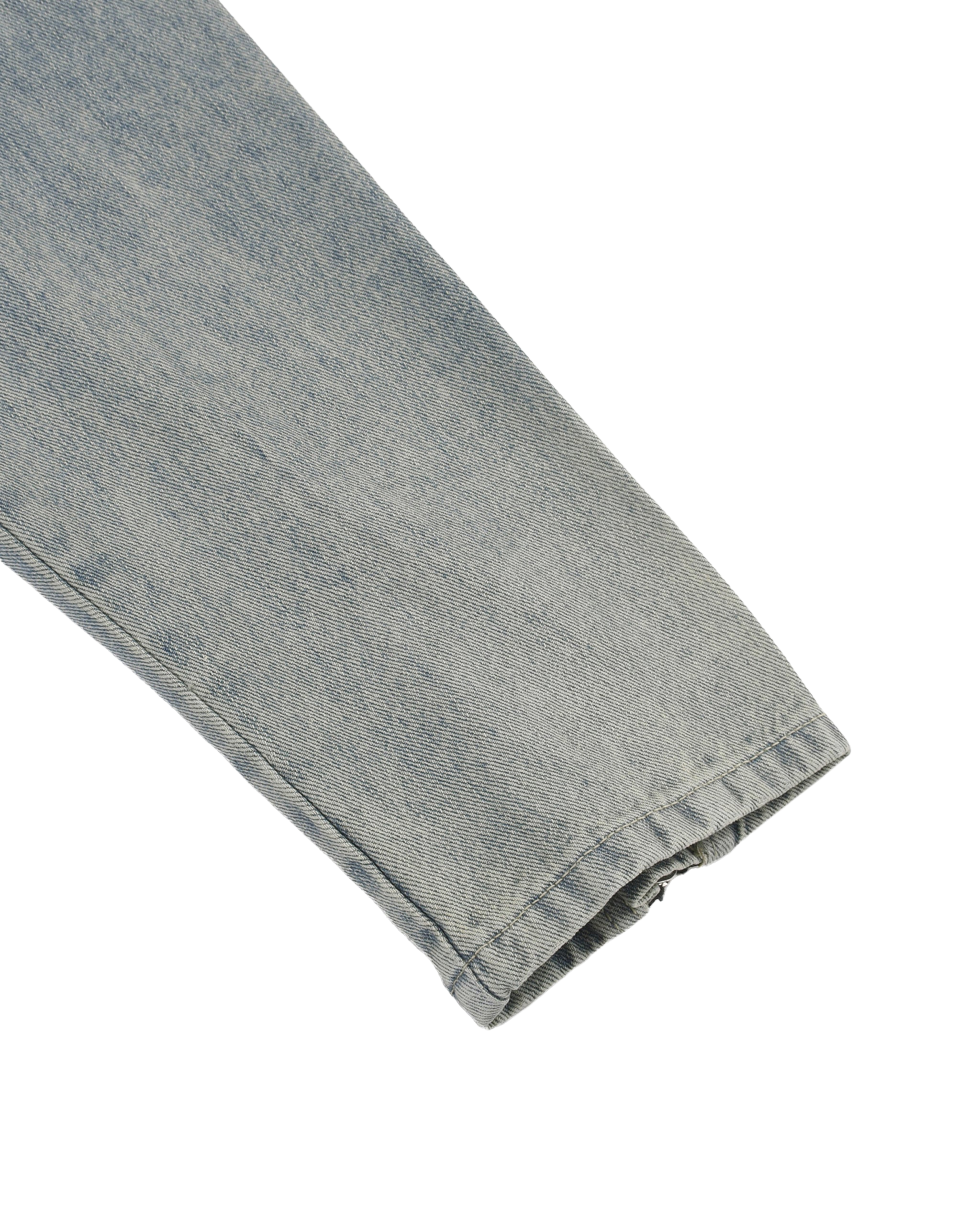 Close-up of a folded denim fabric on a white background
