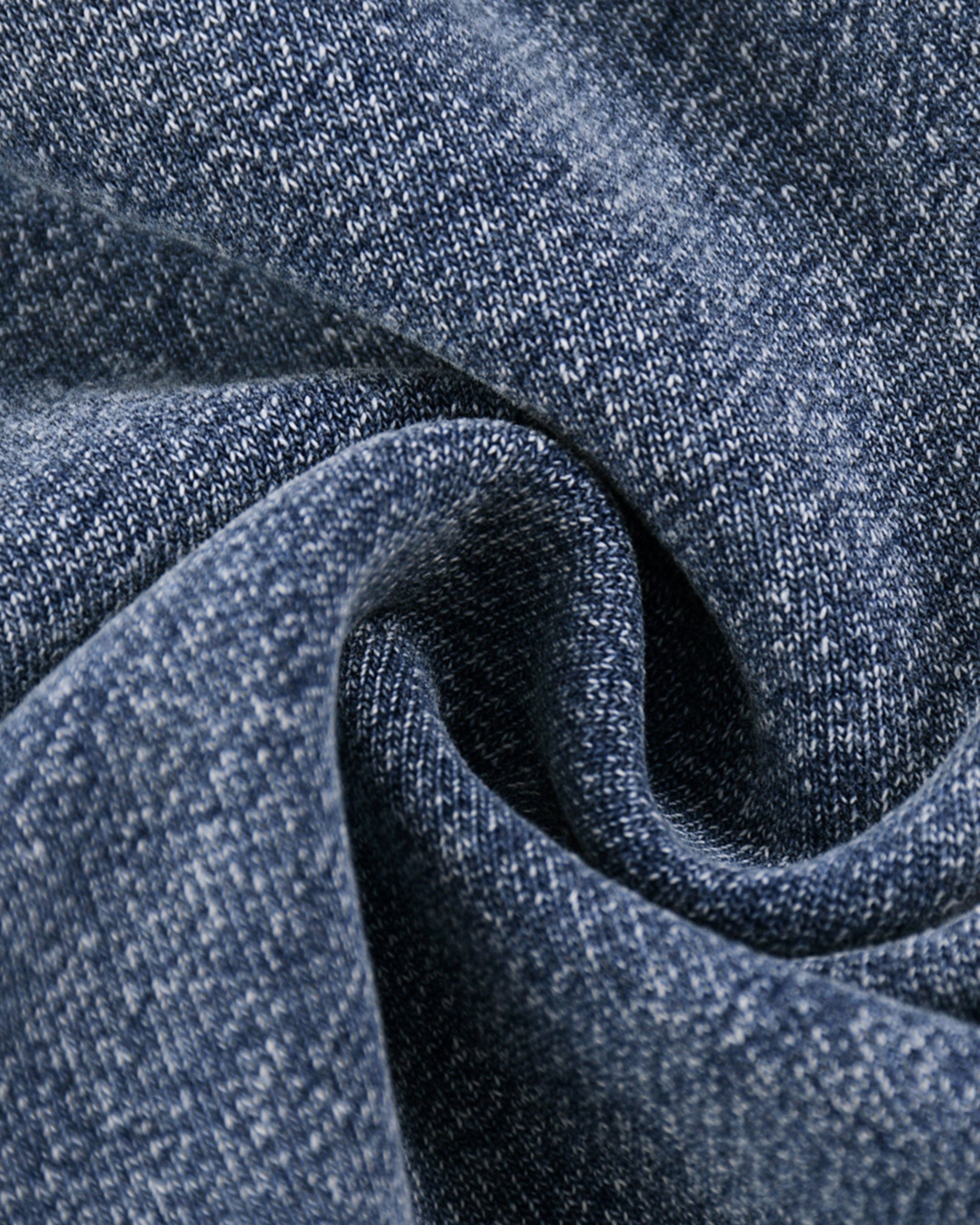 Close-up of blue denim fabric with a subtle pattern