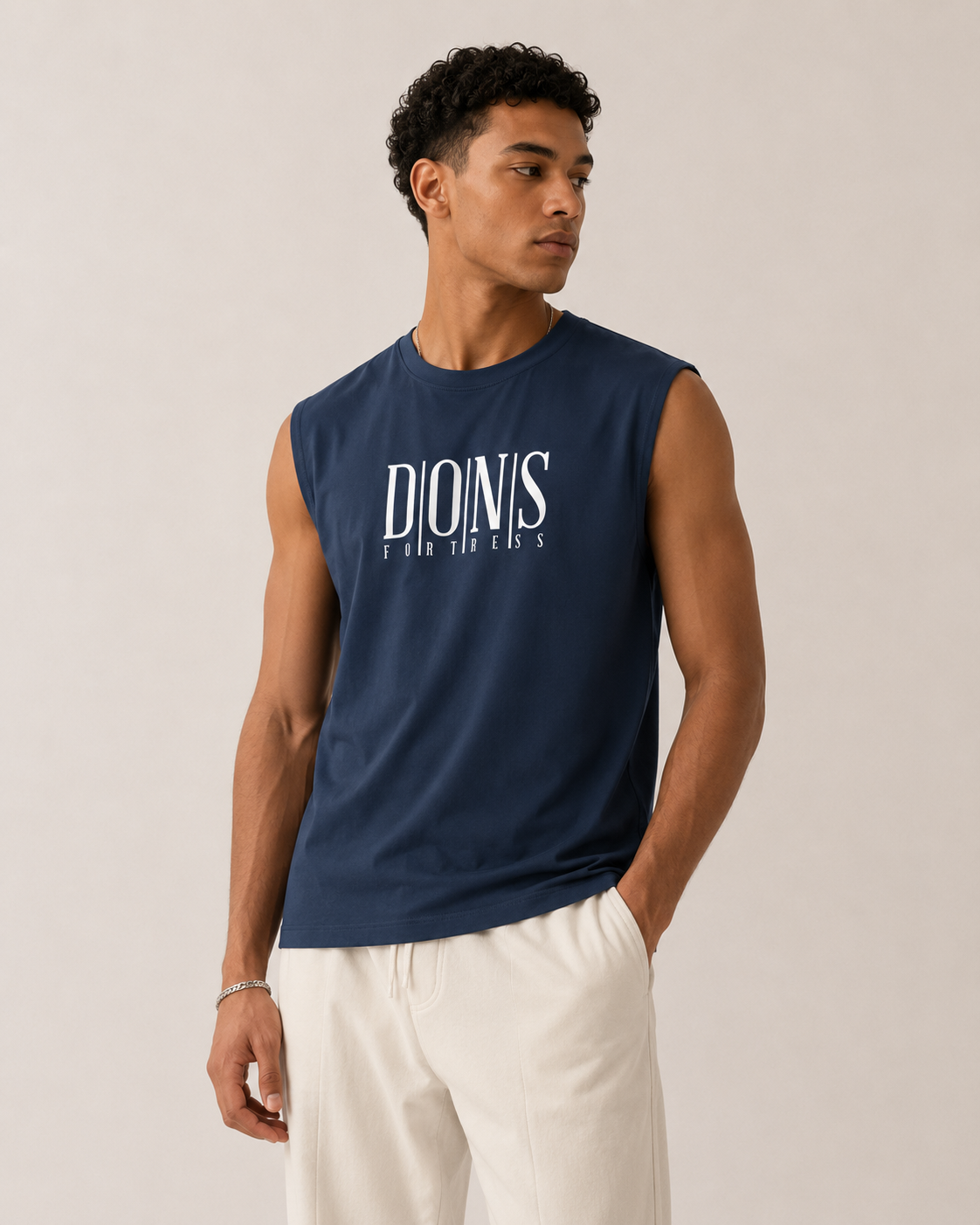 Man wearing a navy sleeveless shirt with 'Dionis' logo on a beige background