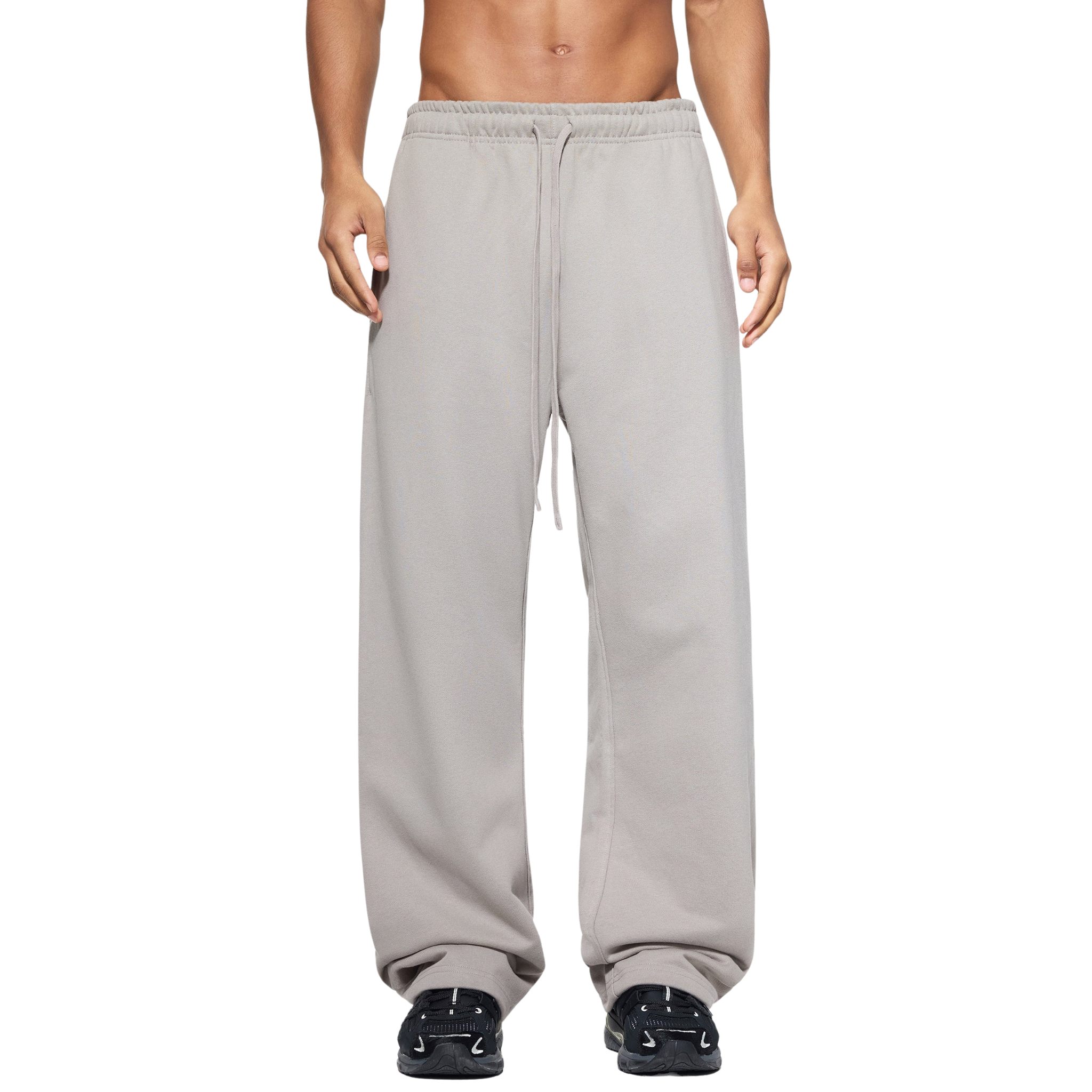 Person wearing gray sweatpants on a white background
