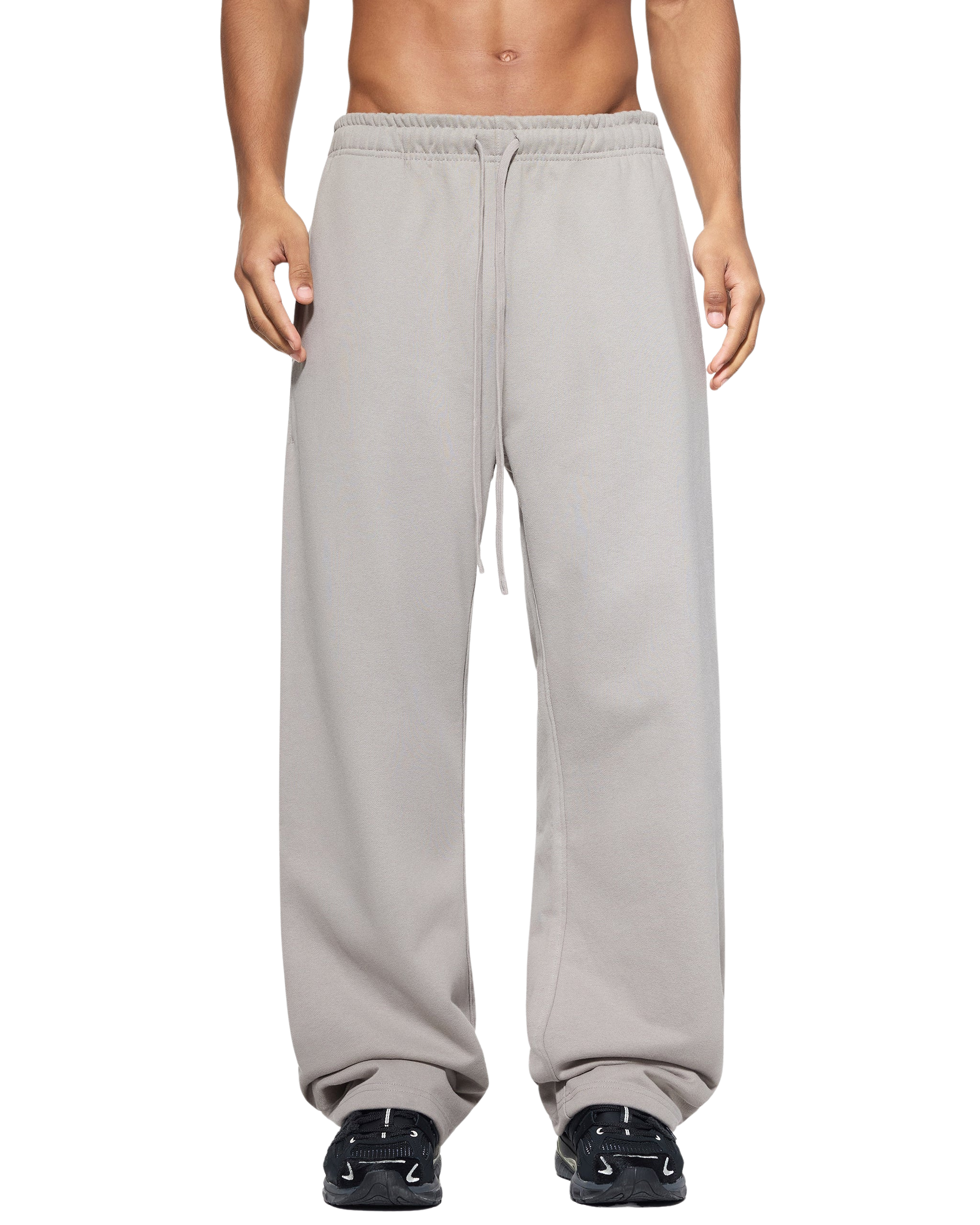 Person wearing gray sweatpants on a white background