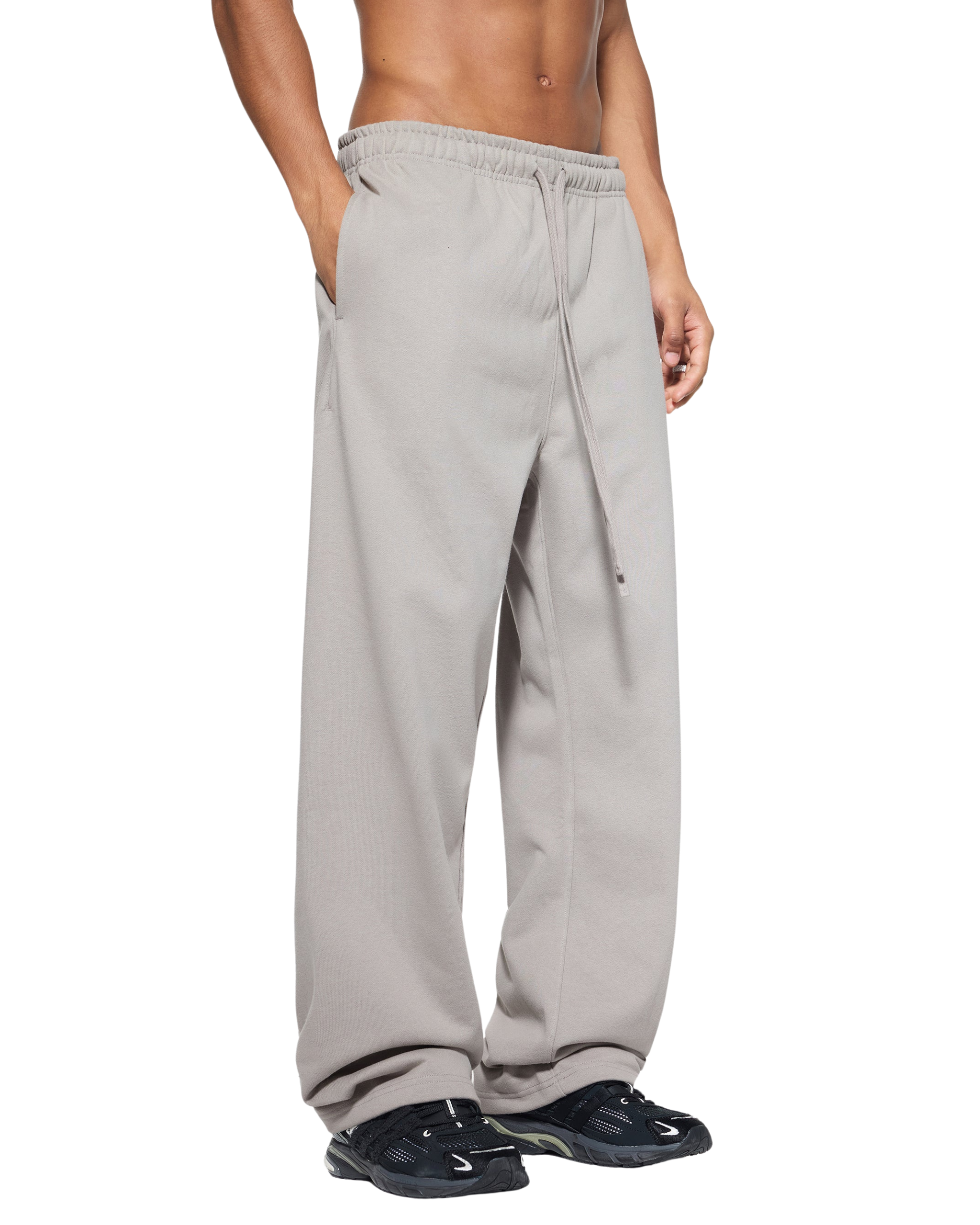 Person wearing light gray sweatpants on a white background