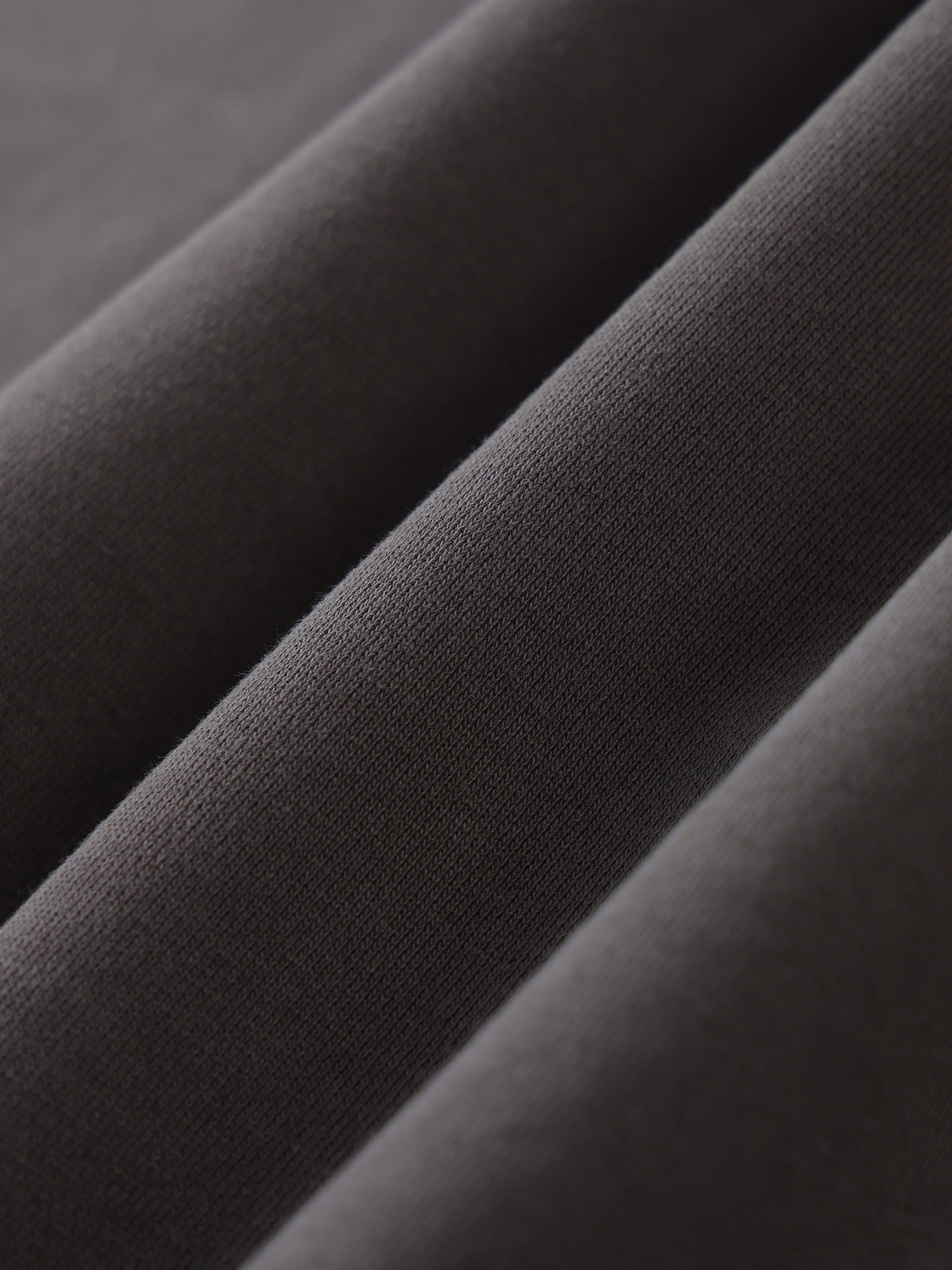 Close-up of dark gray fabric with a subtle pattern