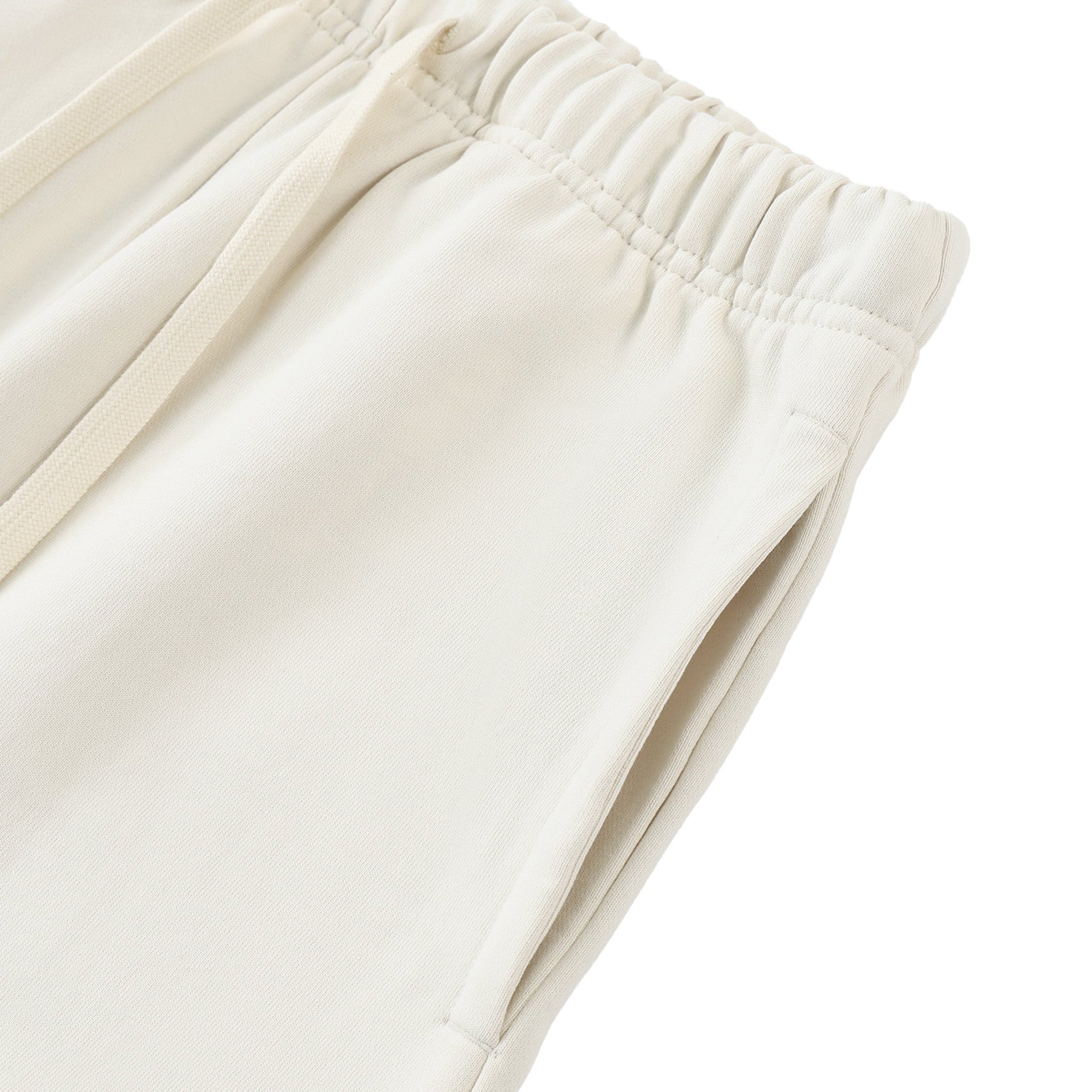 Close-up of beige pants on a white background