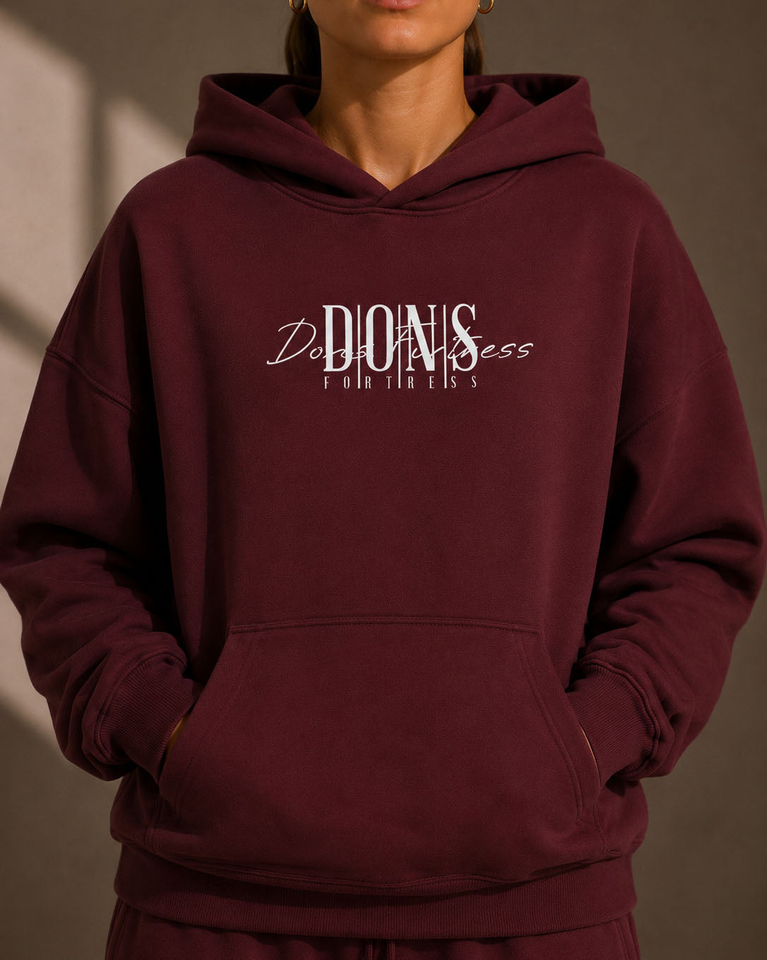 Maroon hoodie with text on a plain background