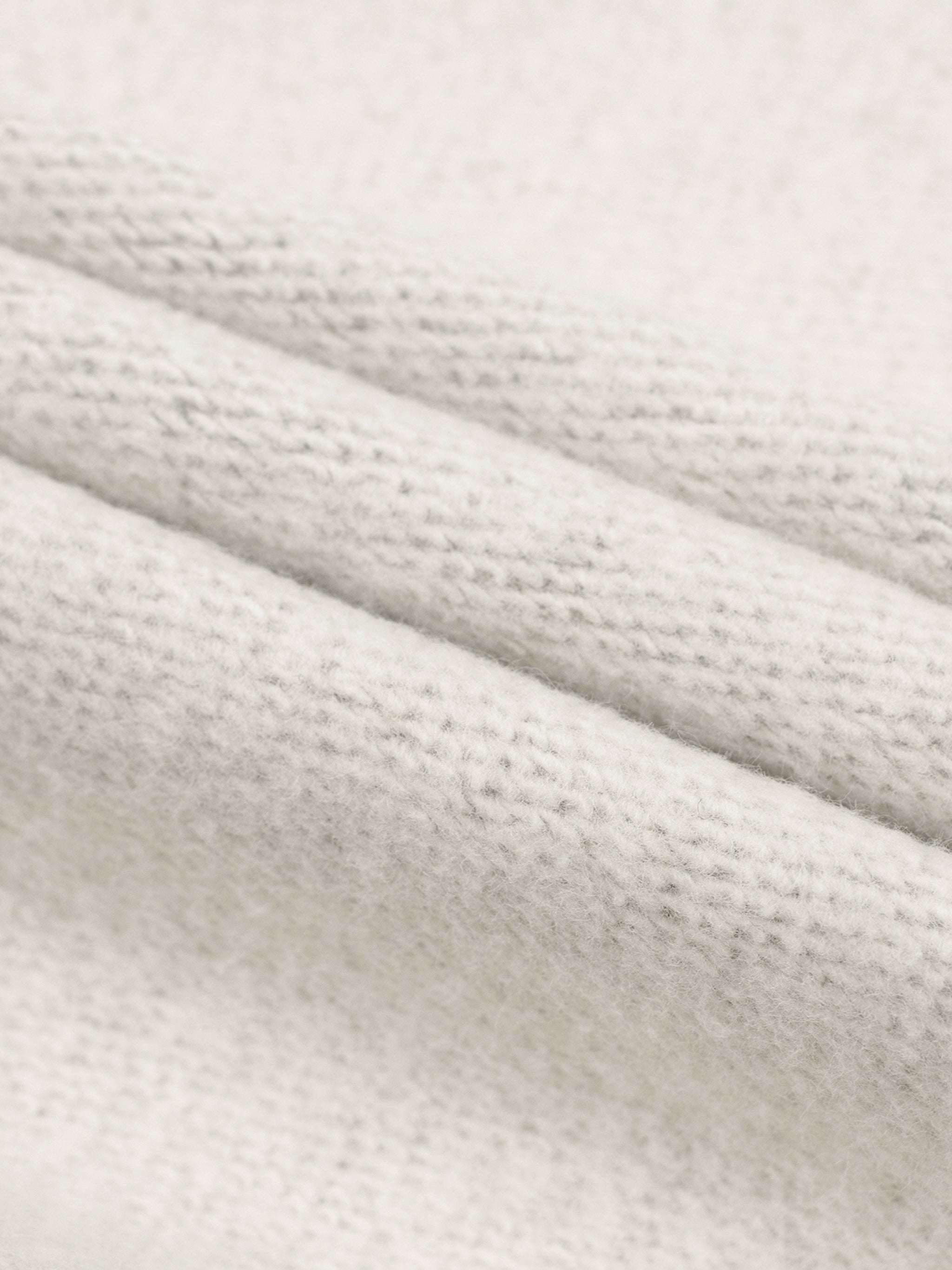 Close-up of textured white fabric with a subtle pattern