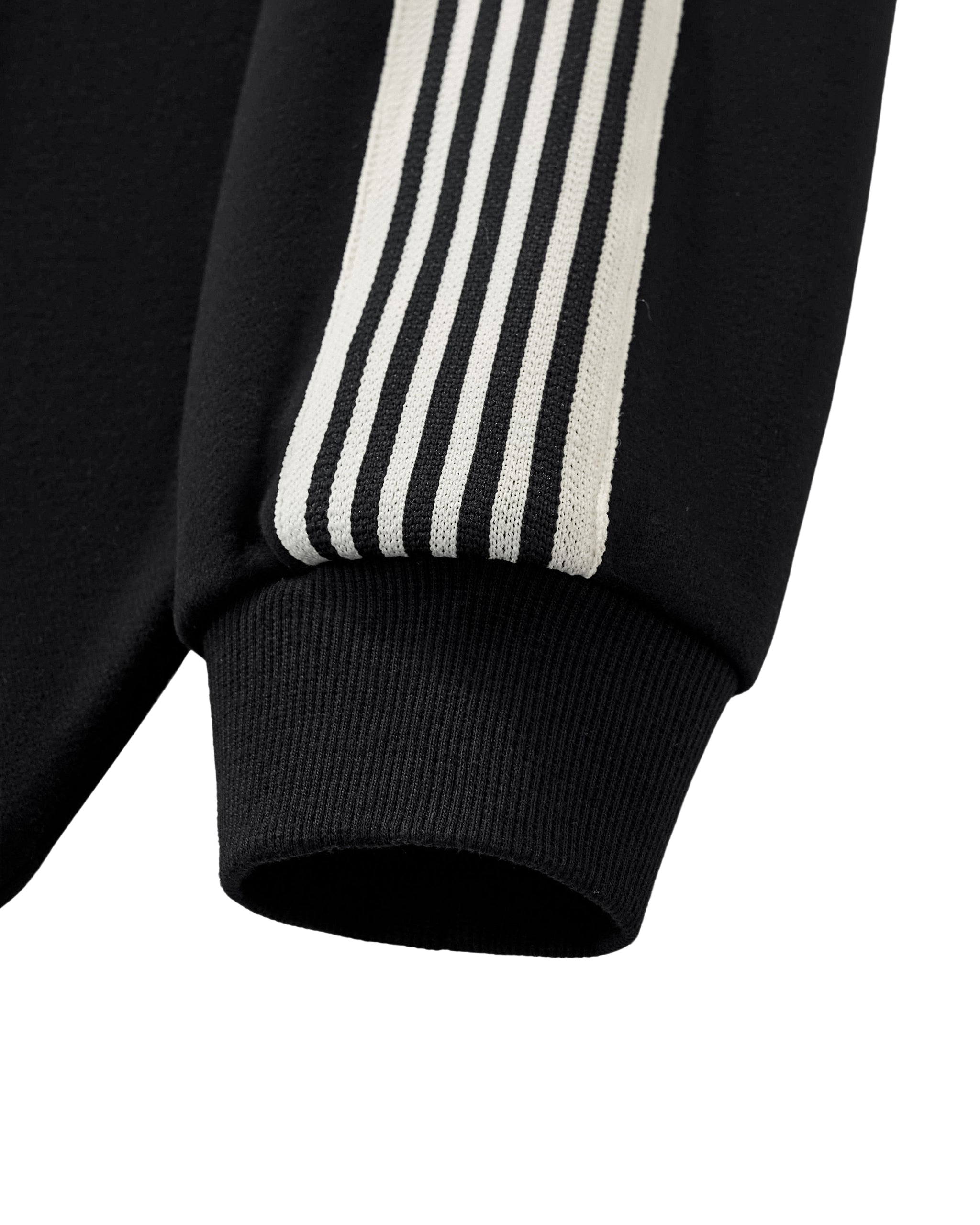 Close-up of a black sweatshirt with white stripes on a white background