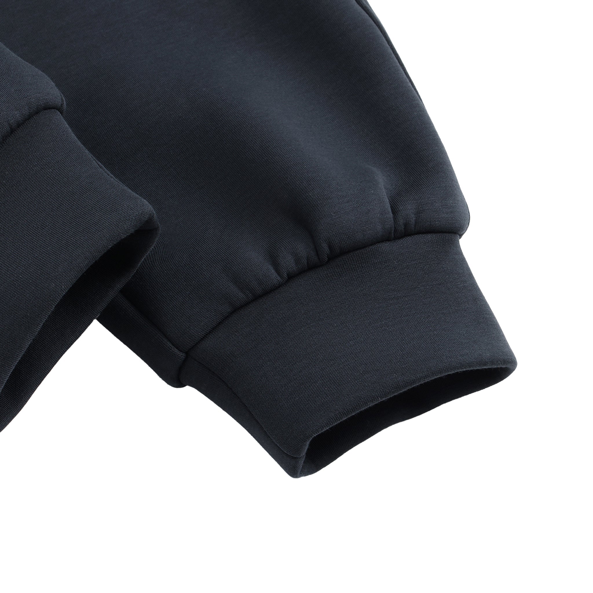 Close-up of a dark blue fabric sleeve on a white background