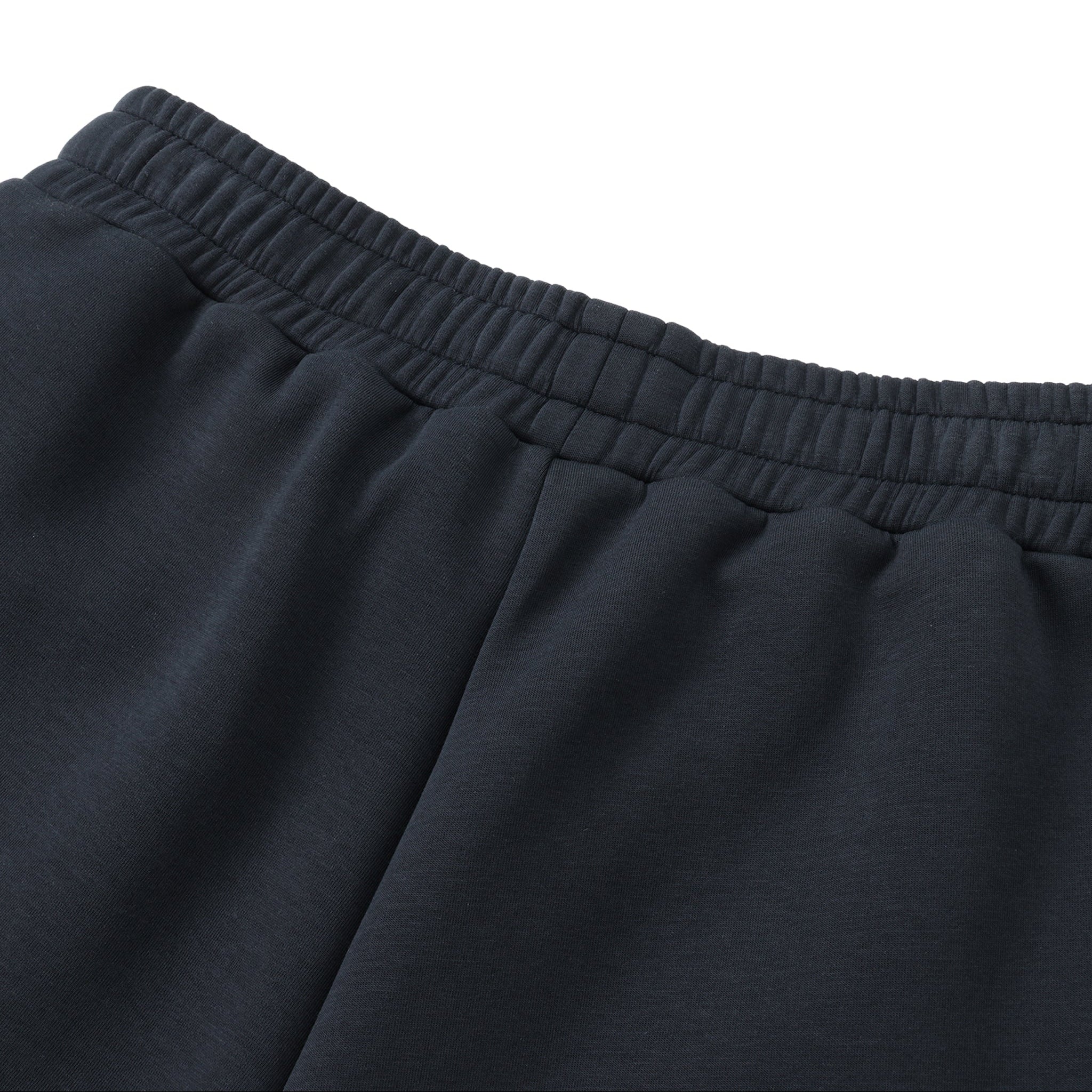 Close-up of dark blue pants with an elastic waistband on a white background