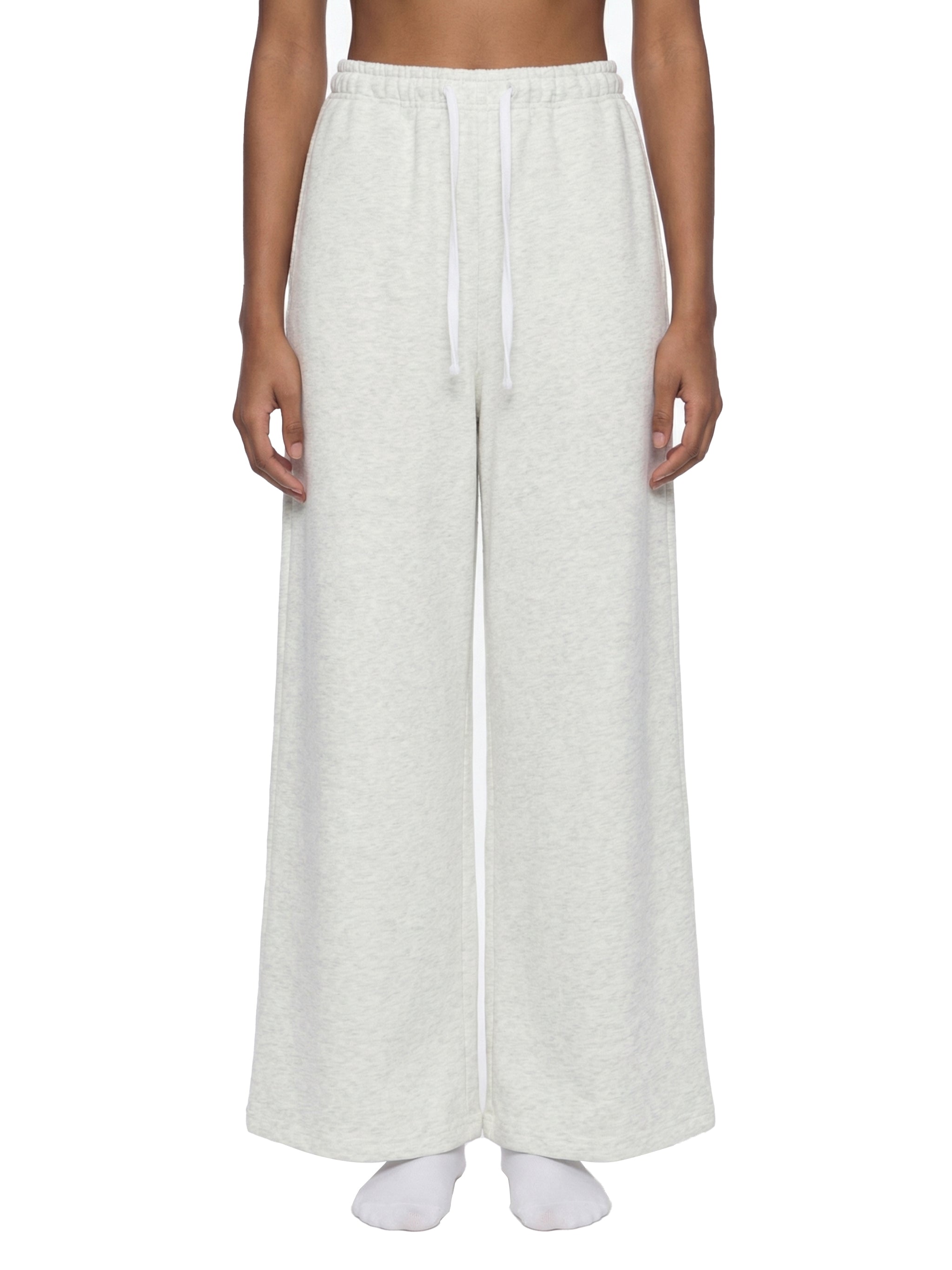 Person wearing white wide-leg pants on a white background