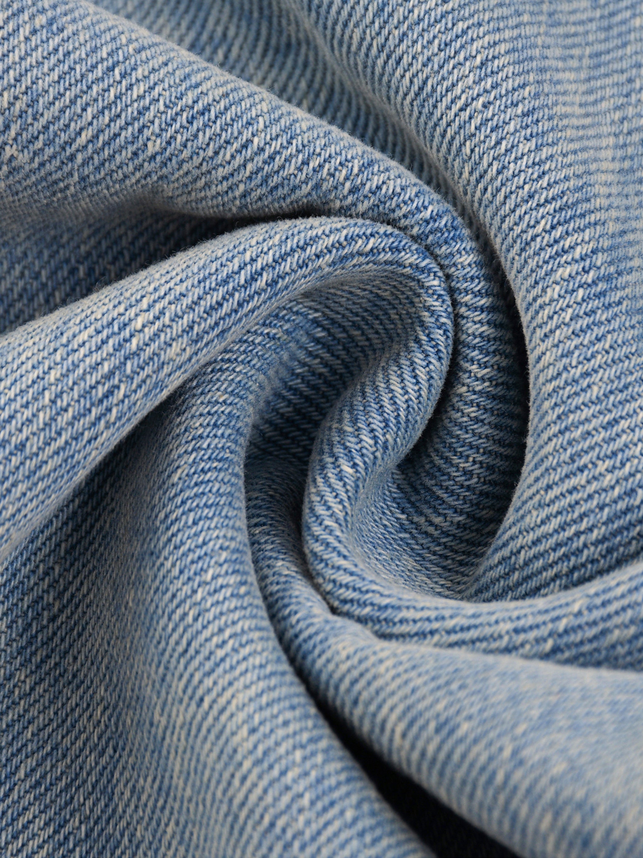 Close-up of blue denim fabric with a swirl pattern