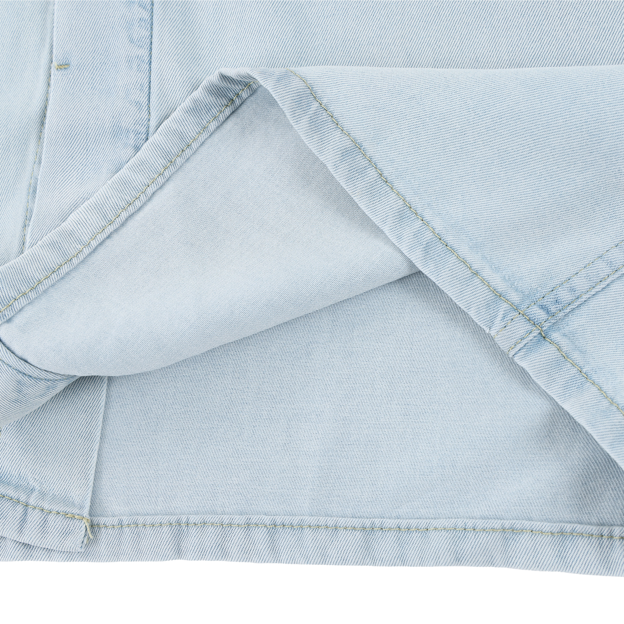 Close-up of light blue denim fabric with a white background