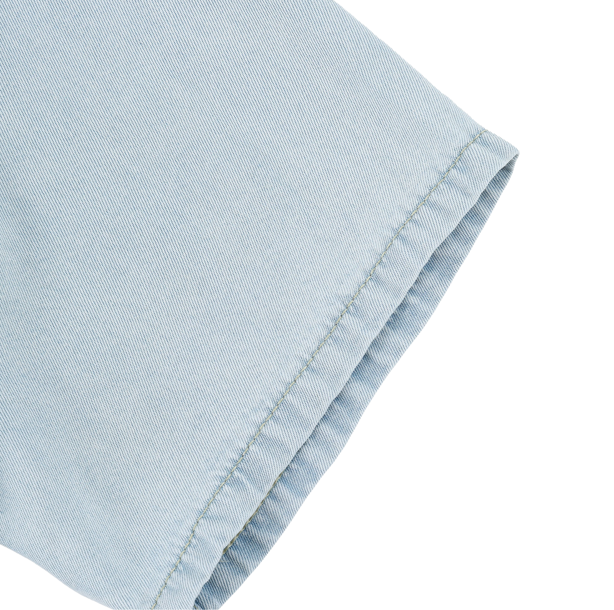 Close-up of light blue denim fabric with a white background