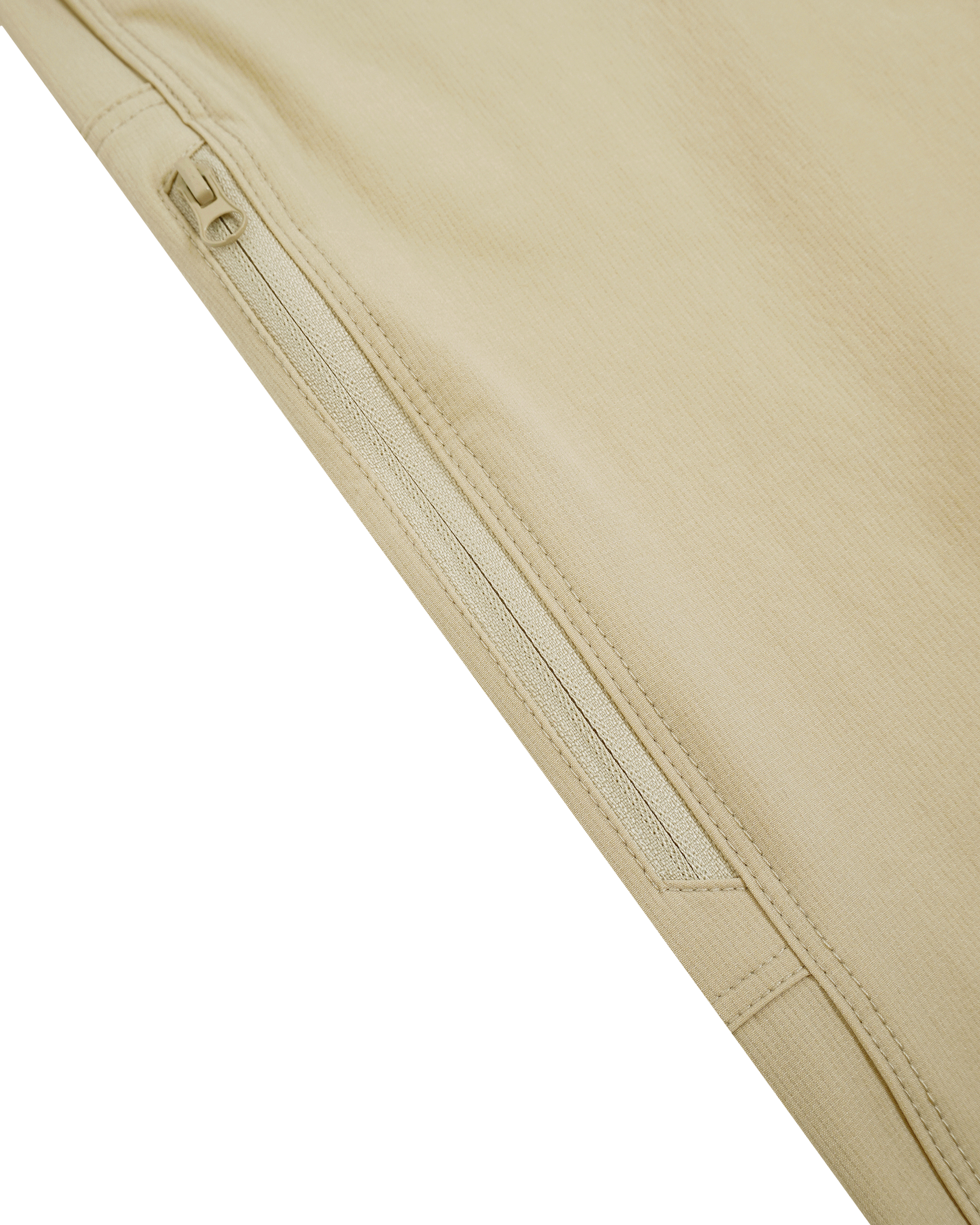 Close-up of beige pants with a zip on a white background