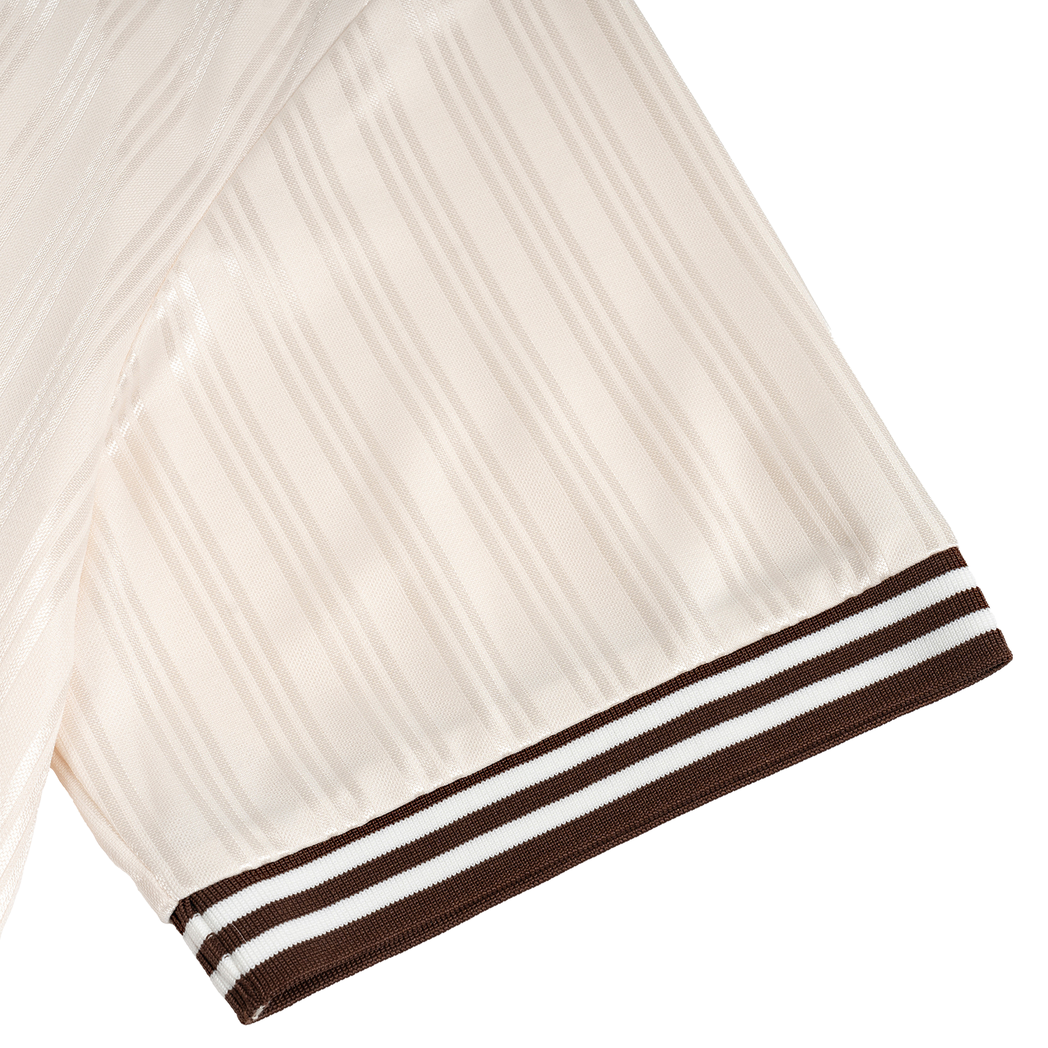 Close-up of a white pleated garment with brown and white striped trim on a black background