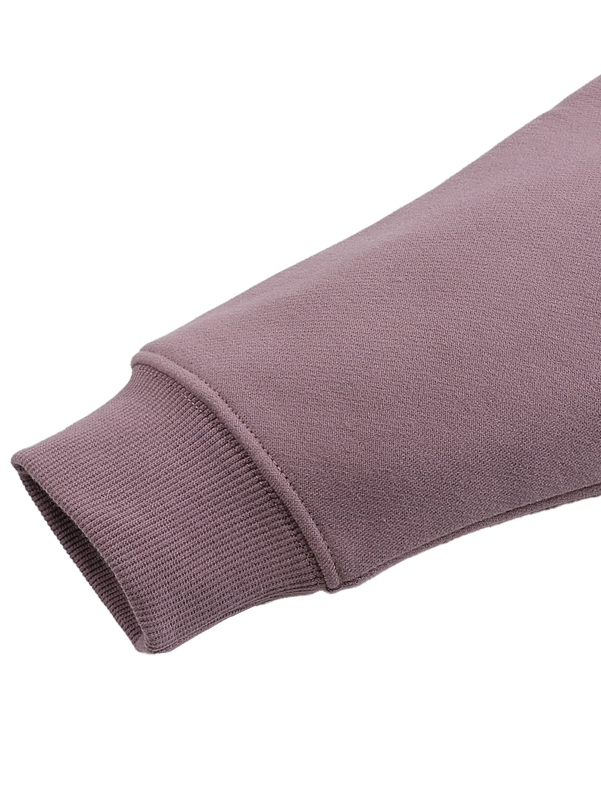Close-up of a purple sweater sleeve on a white background