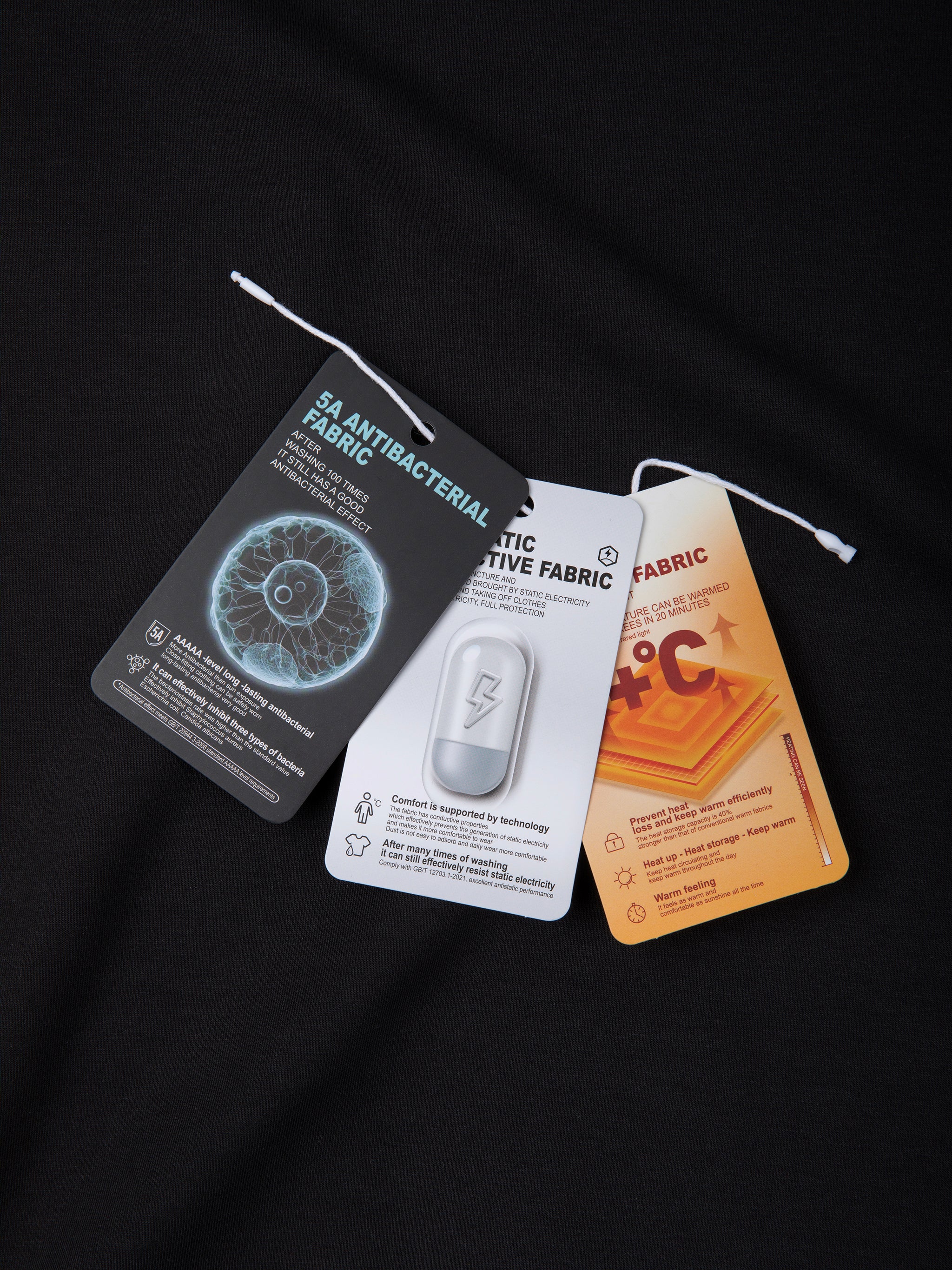 Three fabric tags with different designs and text on a black background