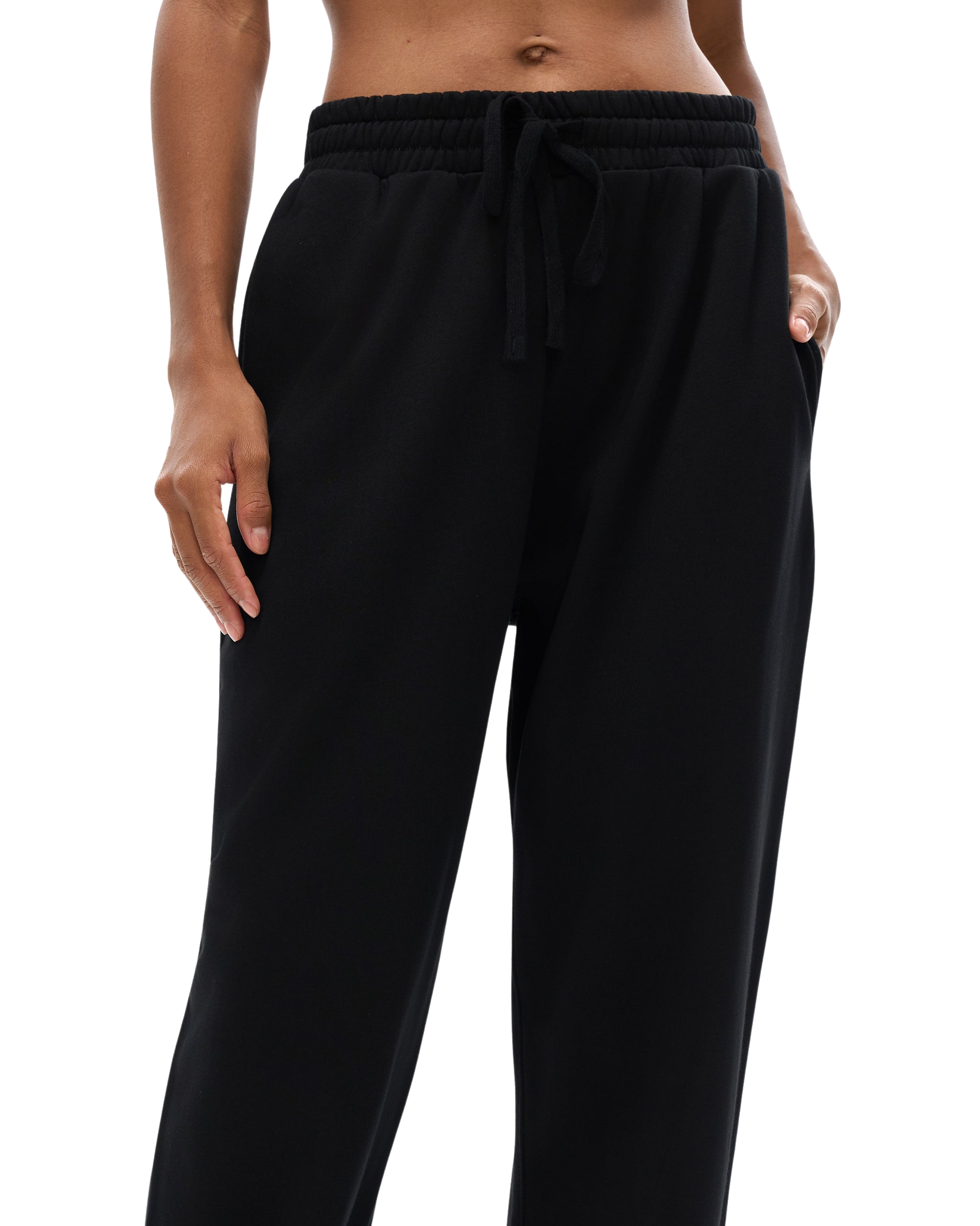 Black pants worn by a person on a white background