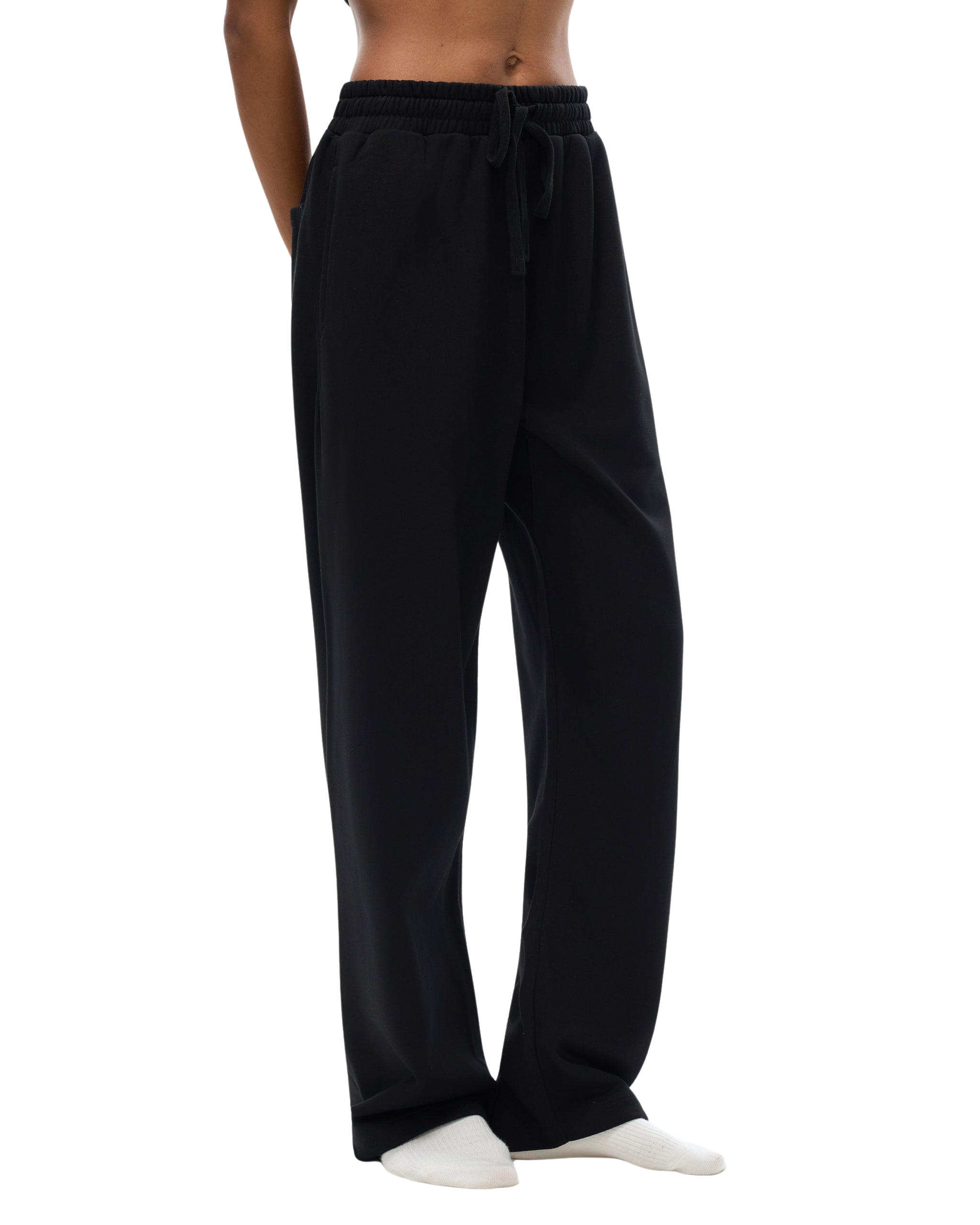 Black pants worn by a person on a white background