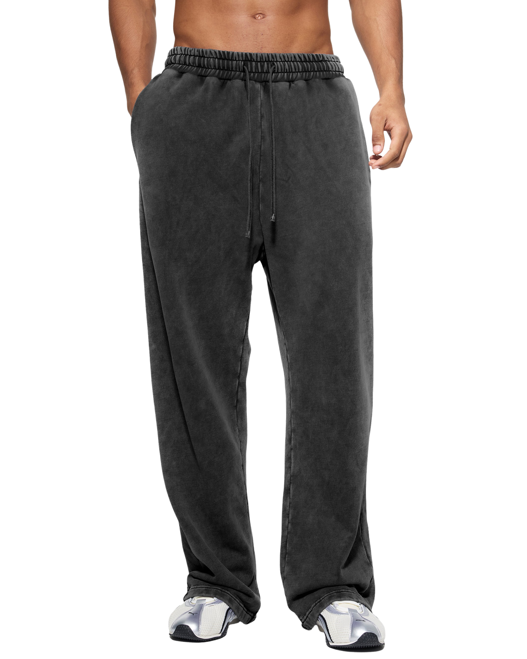 Person wearing dark gray sweatpants on a white background
