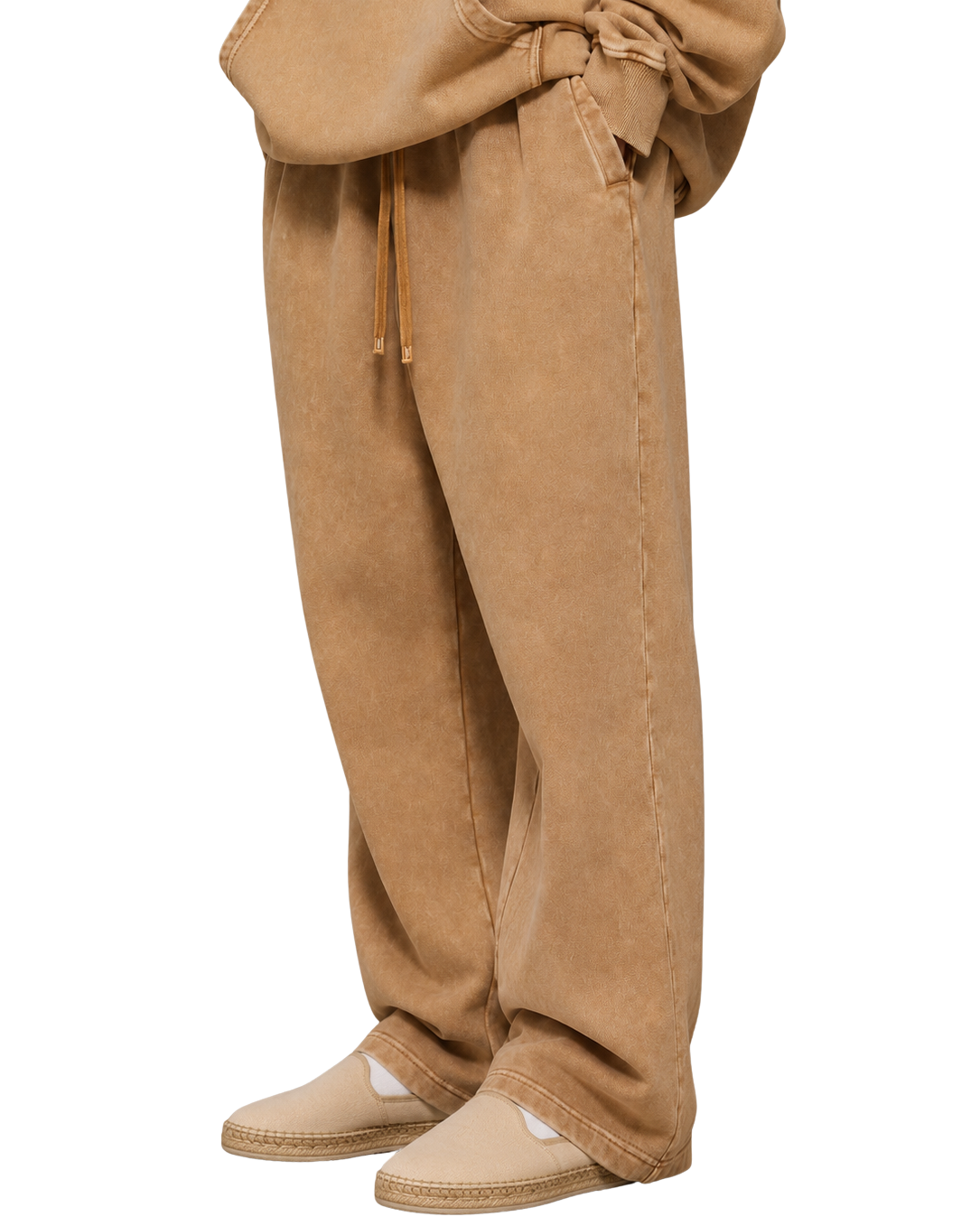 Tan pants worn by a person on a white background