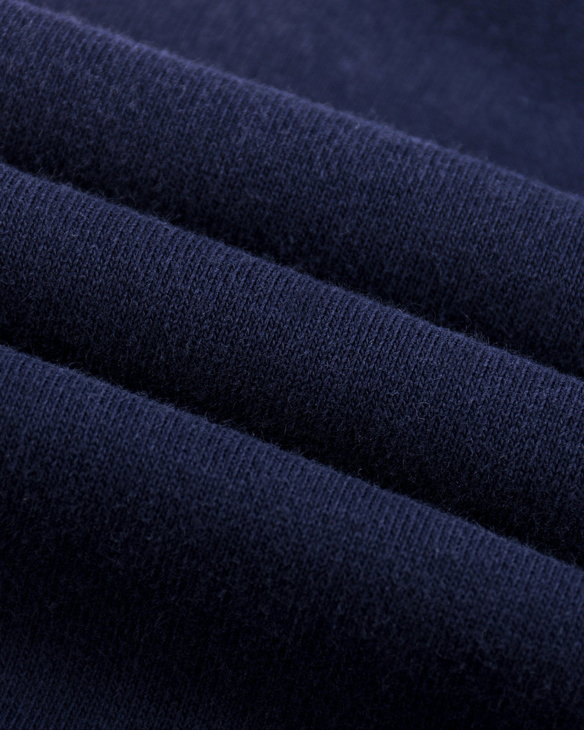 Close-up of dark blue fabric with a textured pattern