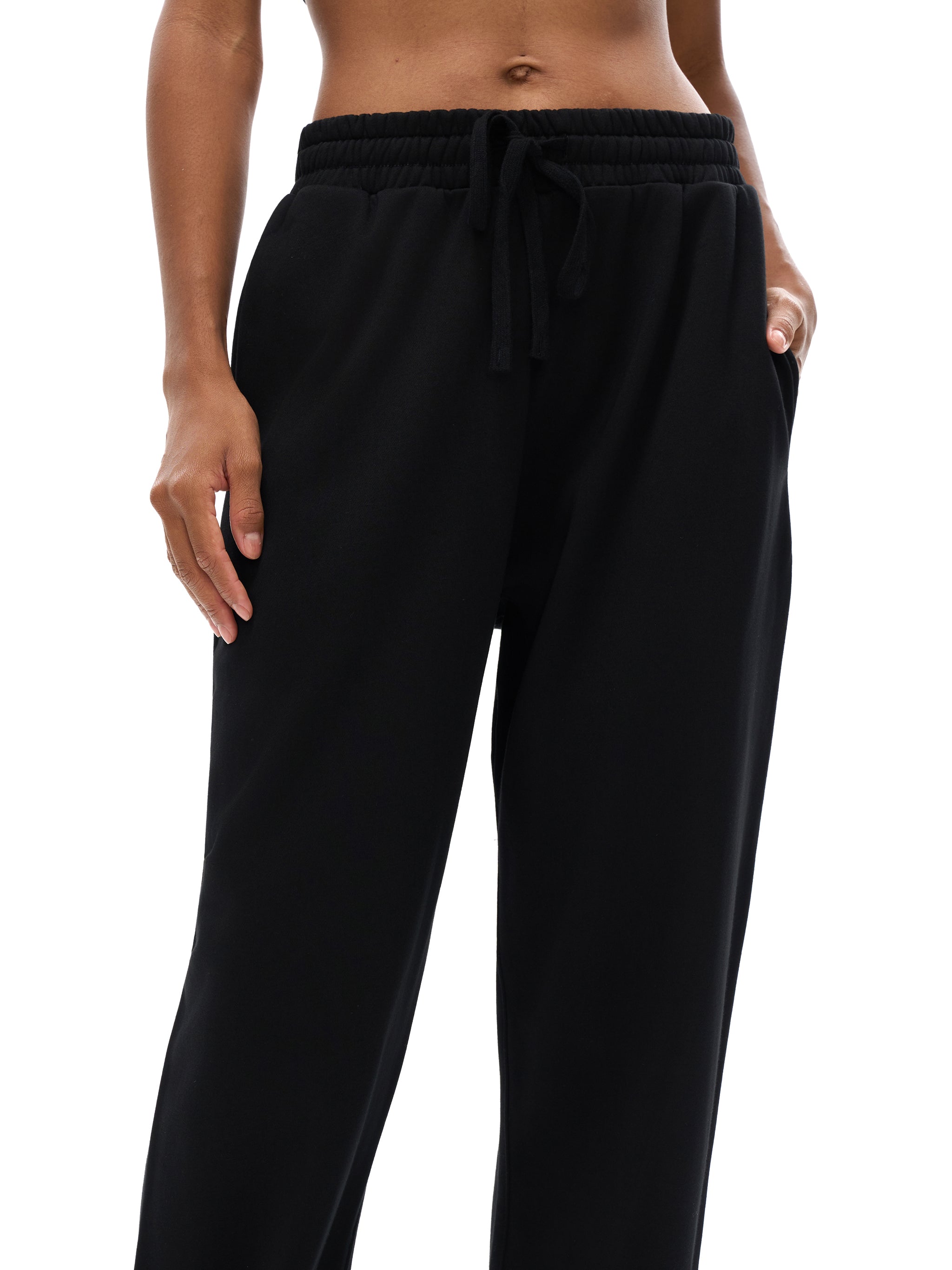 Black pants worn by a person on a white background