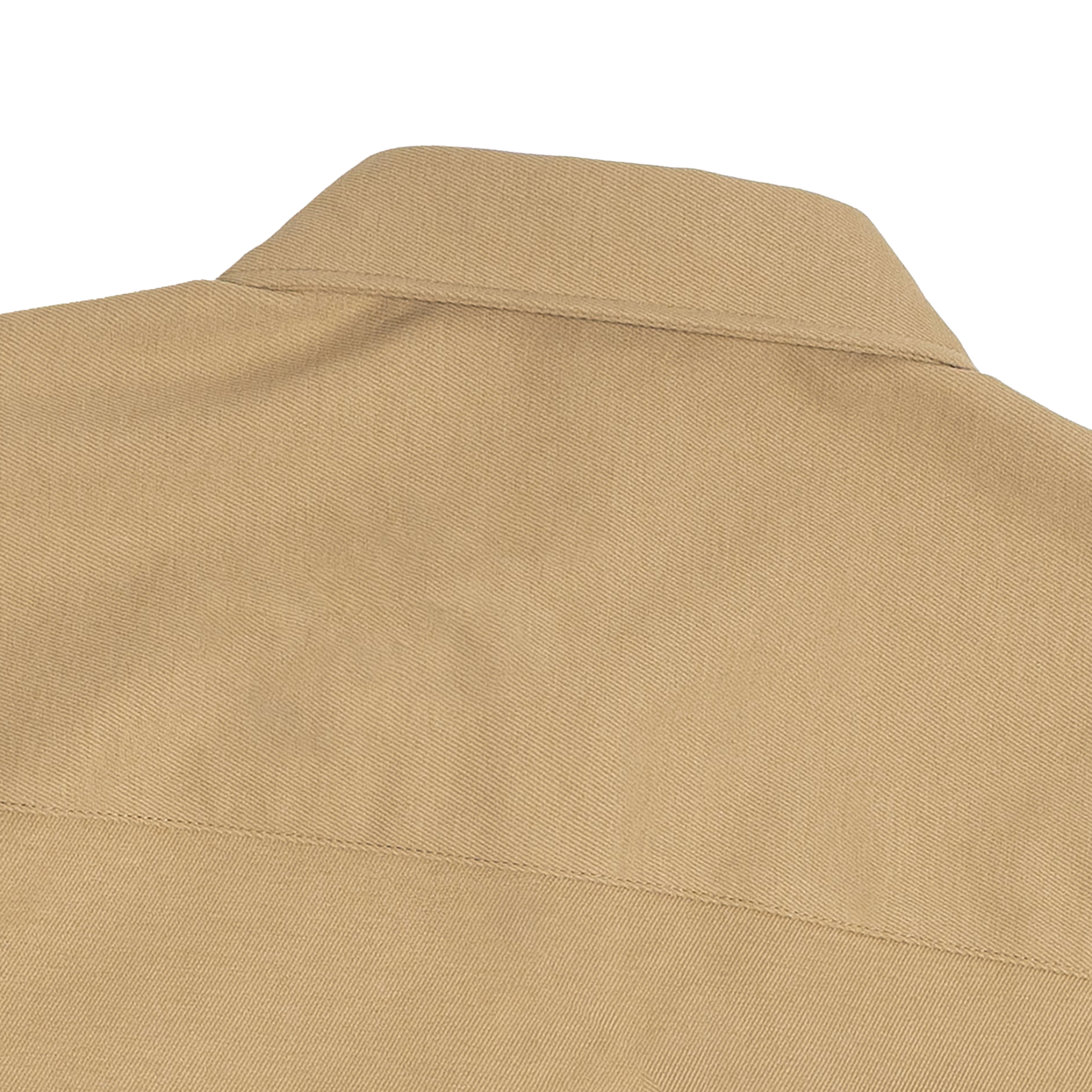 Close-up of a beige shirt collar on a white background