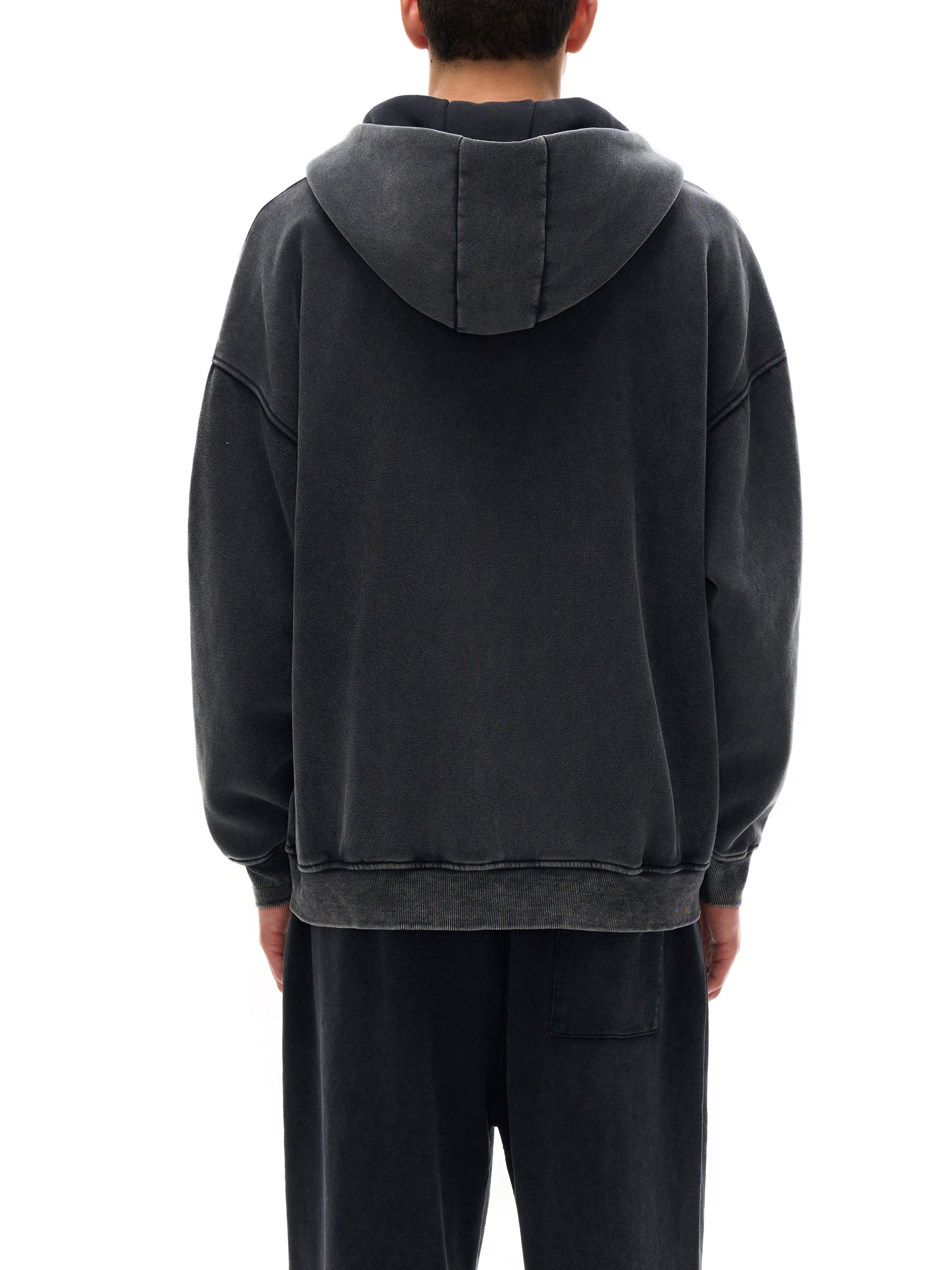 Person wearing a dark gray hoodie from behind on a white background