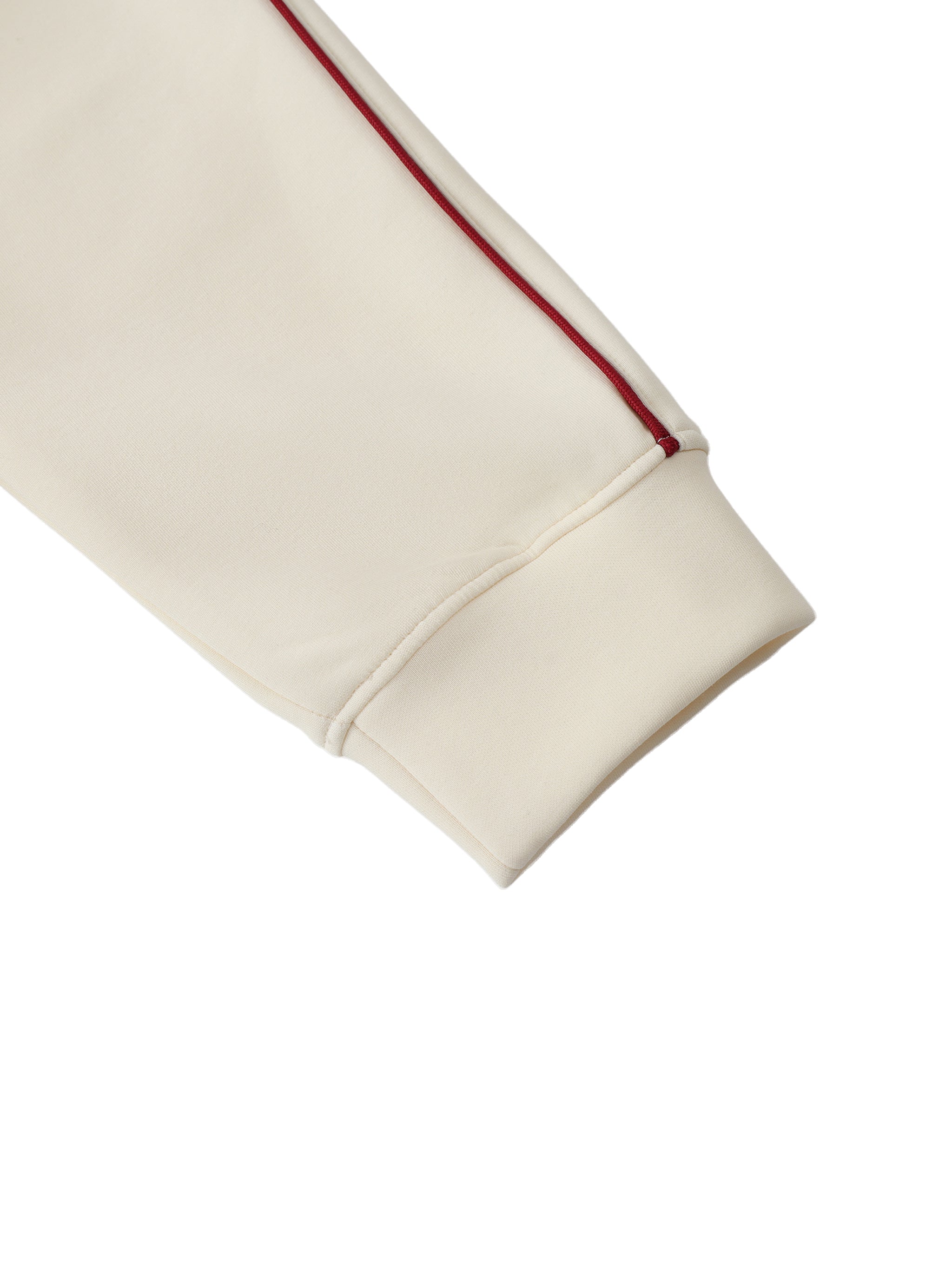 Close-up of a beige fabric with a red stripe on a white background