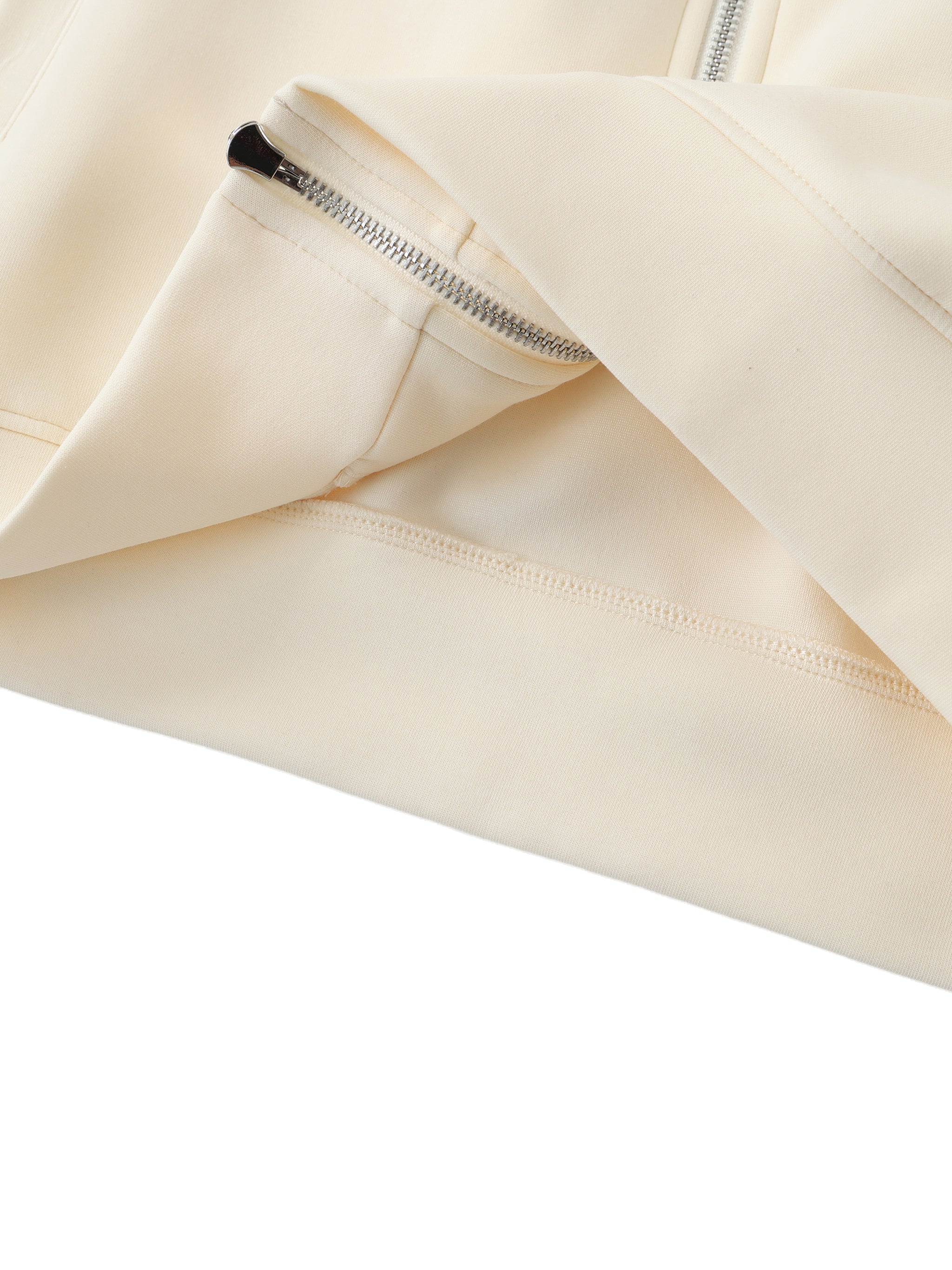 Close-up of a beige garment with a zip on a white background