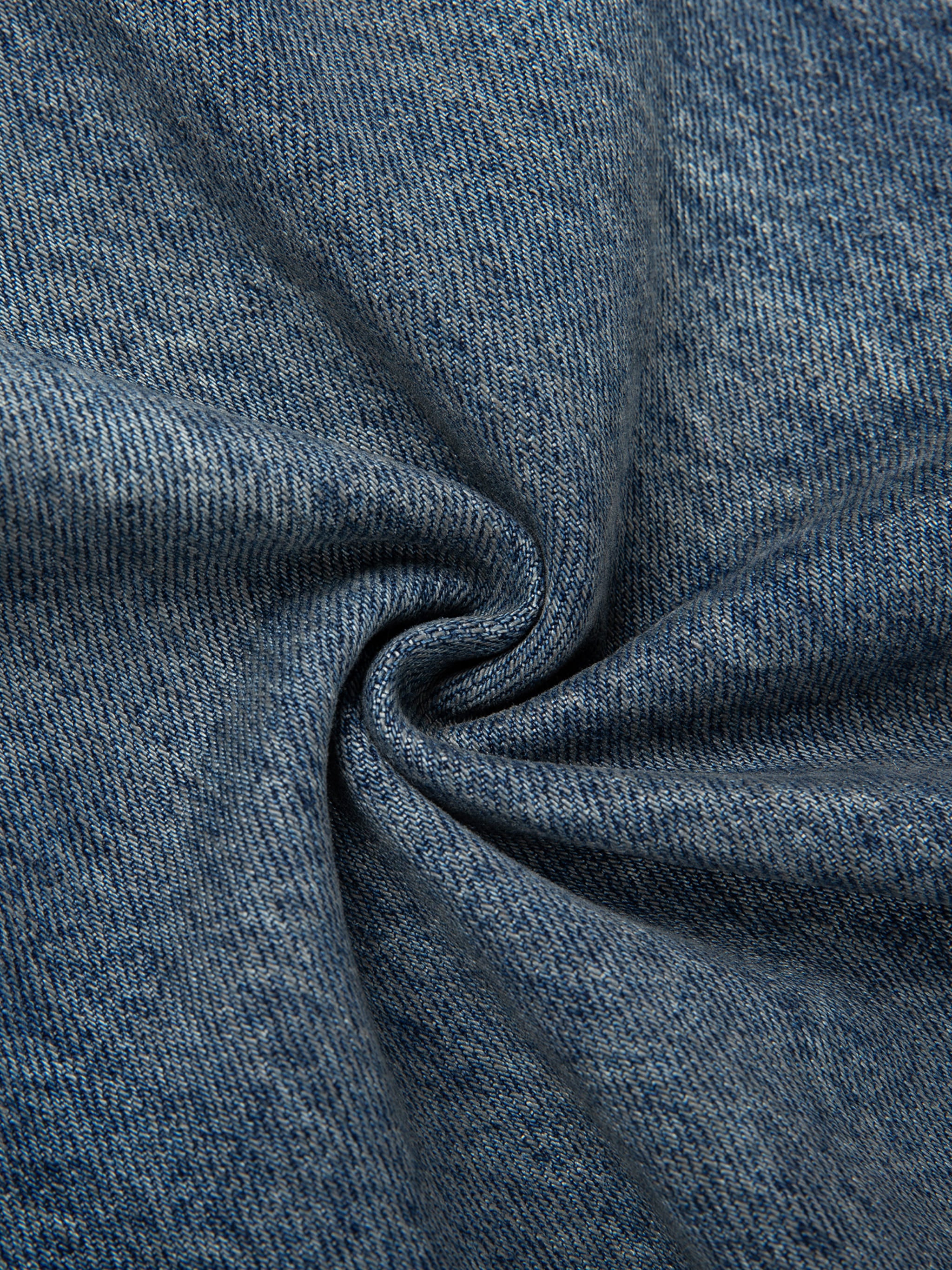 Close-up of blue denim fabric with a swirl pattern