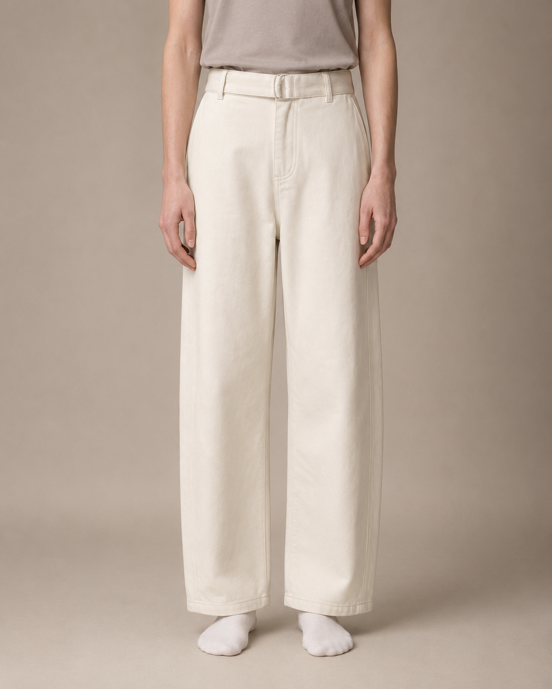 Person wearing light-colored pants and a plain shirt against a neutral background