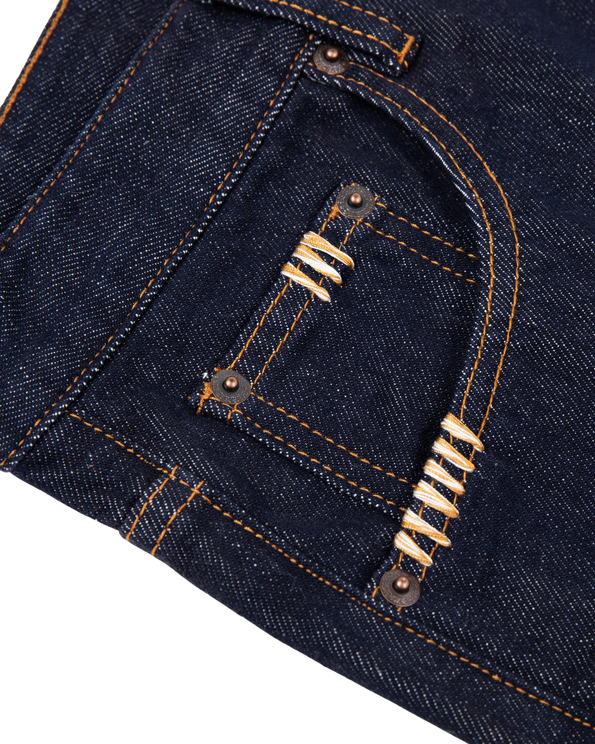 Close-up of dark blue denim fabric with decorative stitching on a white background