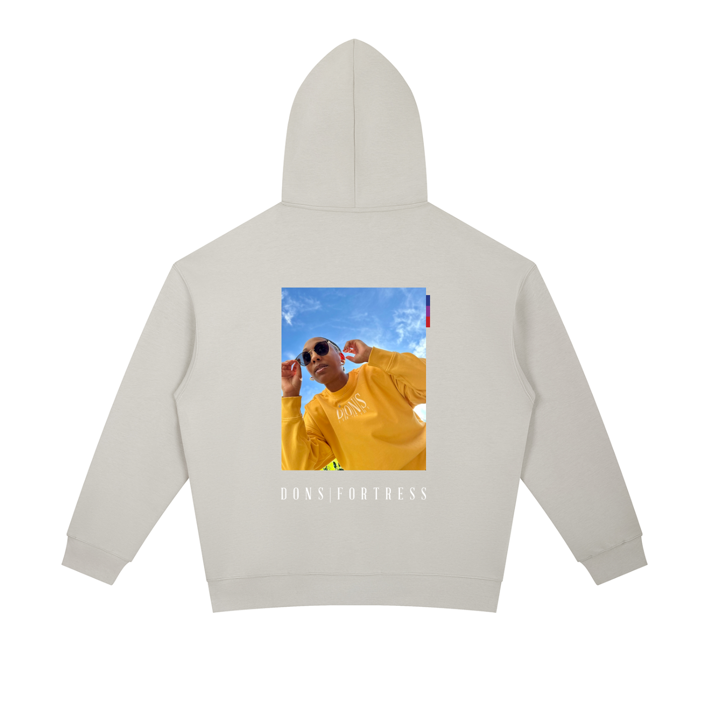 Beige hoodie with a printed design on the back featuring a person in a yellow sweatshirt.