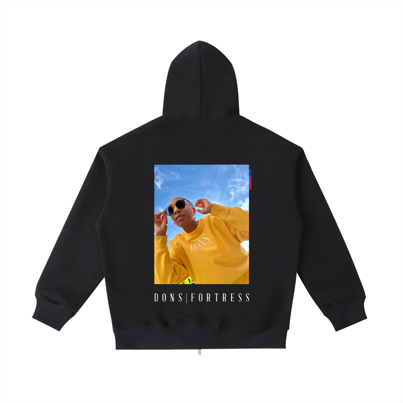 Black hoodie with a printed design on the back featuring a person in a yellow outfit and 'Dons Fortress' text.