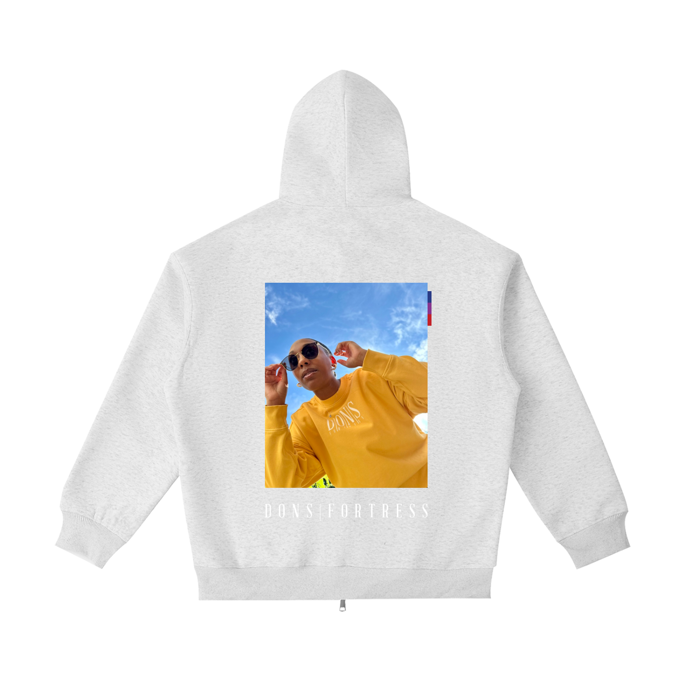 White hoodie with a printed design on the back featuring a person in a yellow shirt and sunglasses against a blue sky.