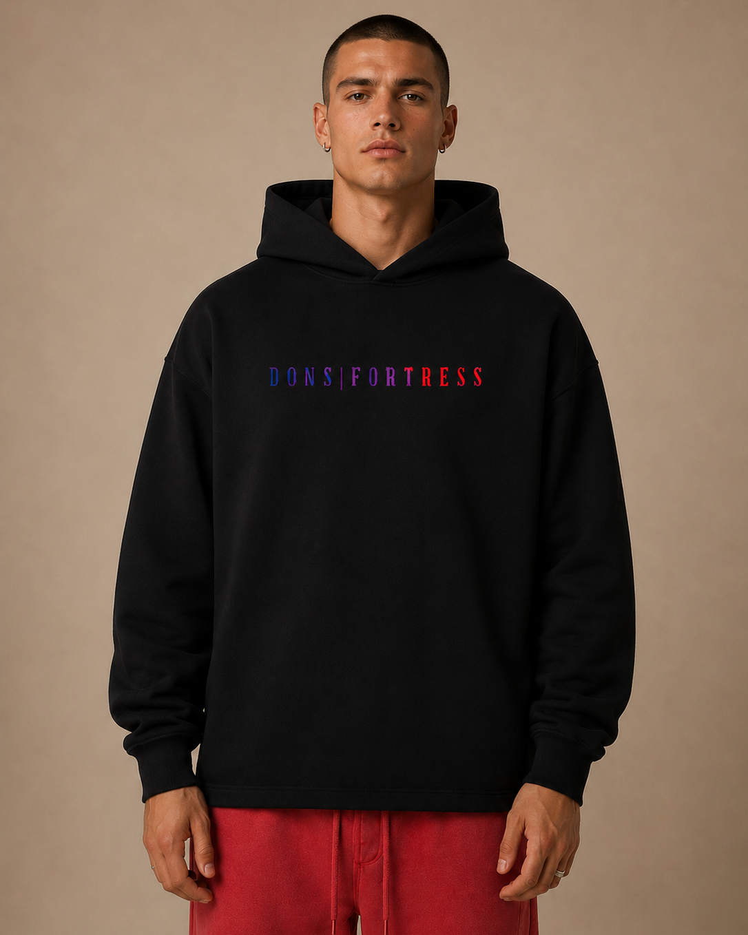 Person wearing a black hoodie with text on a beige background