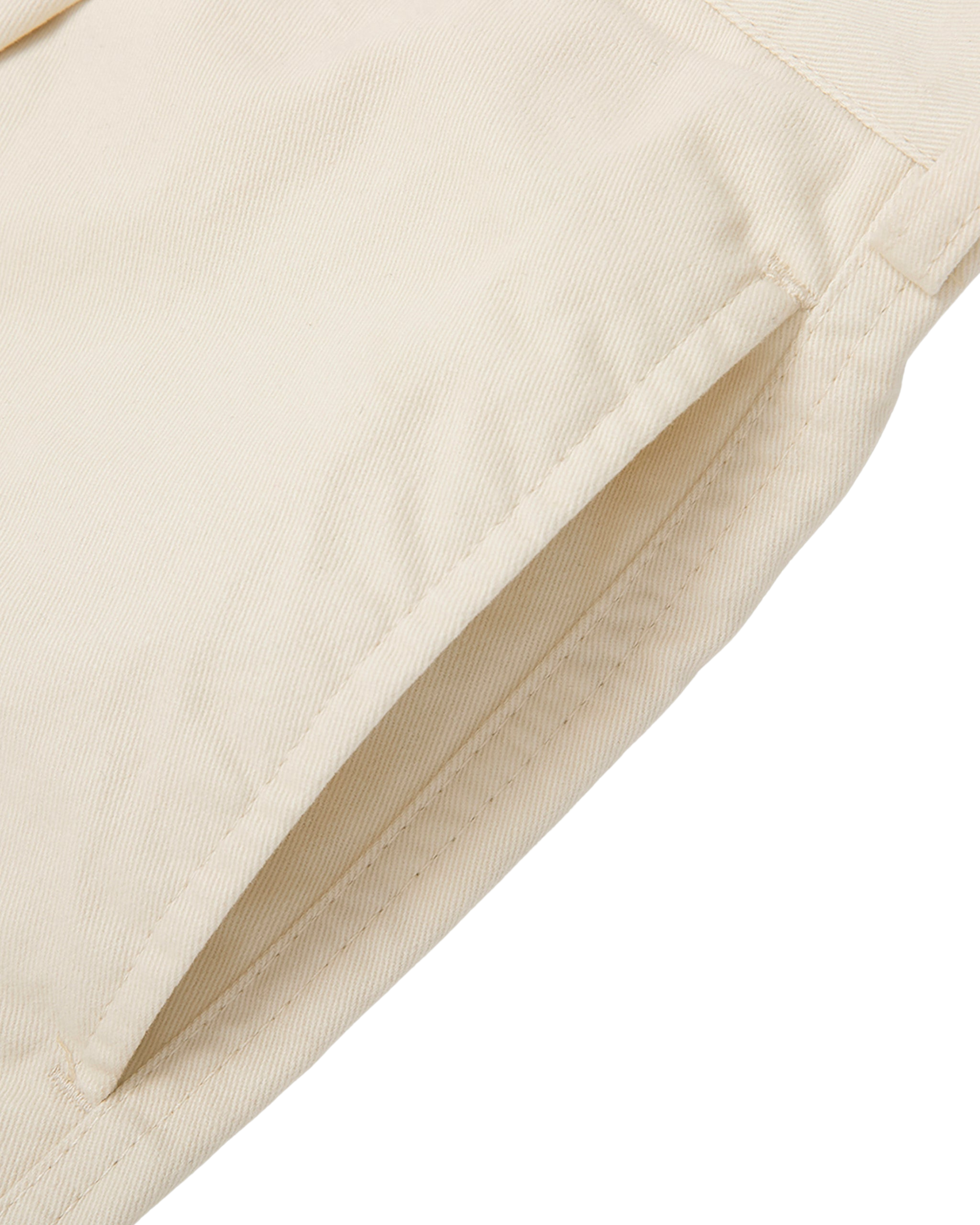 Close-up of beige fabric with a white background