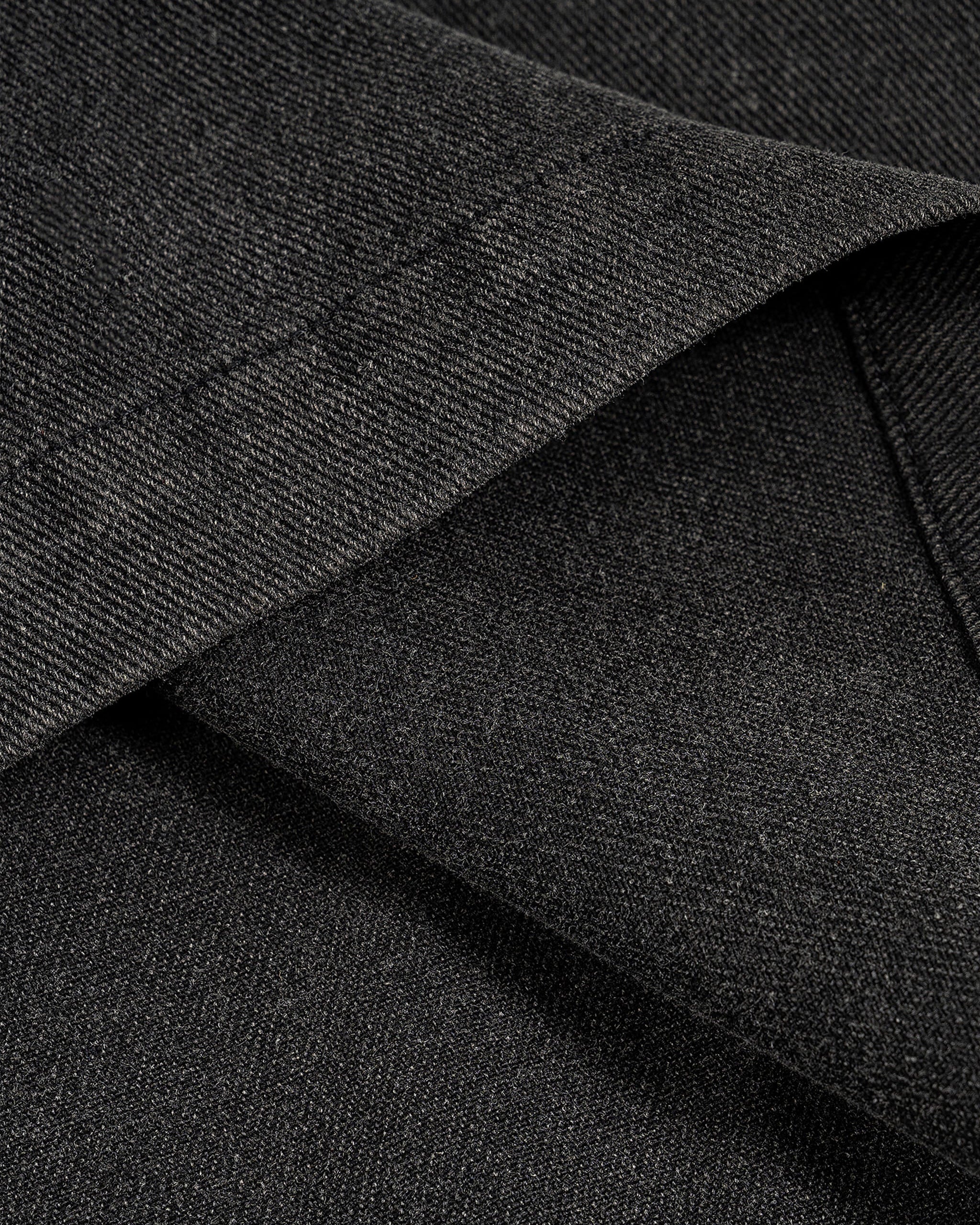 Close-up of dark gray fabric with a textured pattern