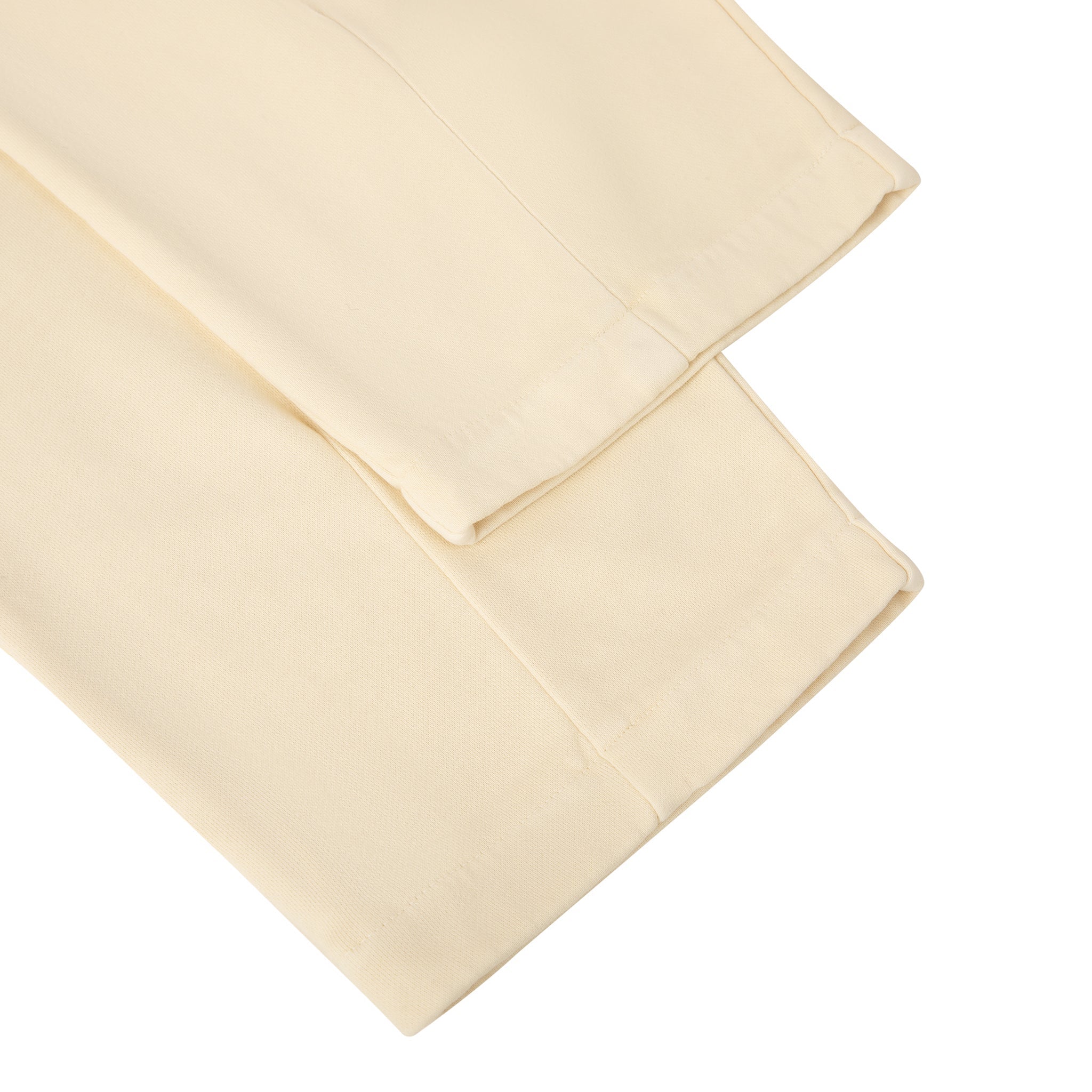 Folded beige bed sheet on a white background